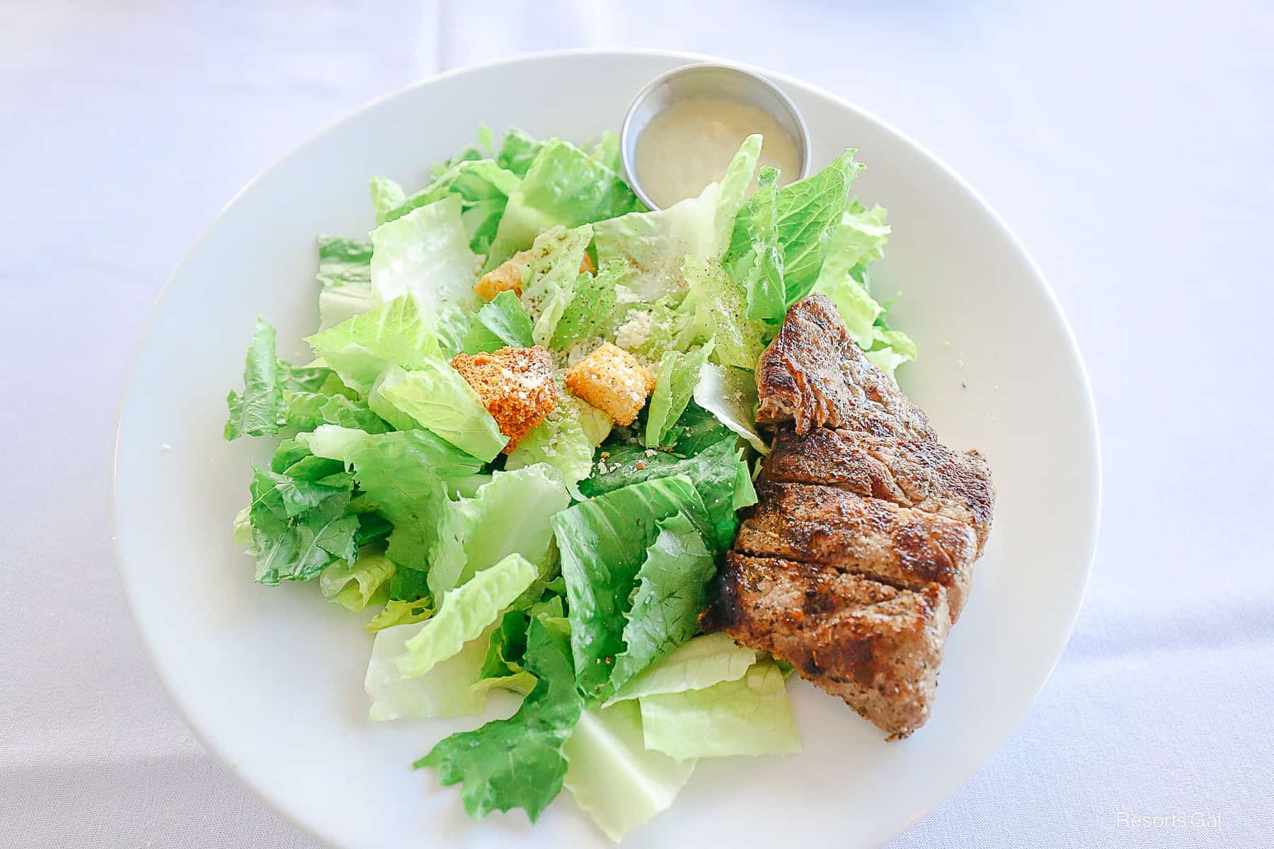 the Caesar Salad from The Boathouse at Disney Springs with a side of New York Strip Steak 