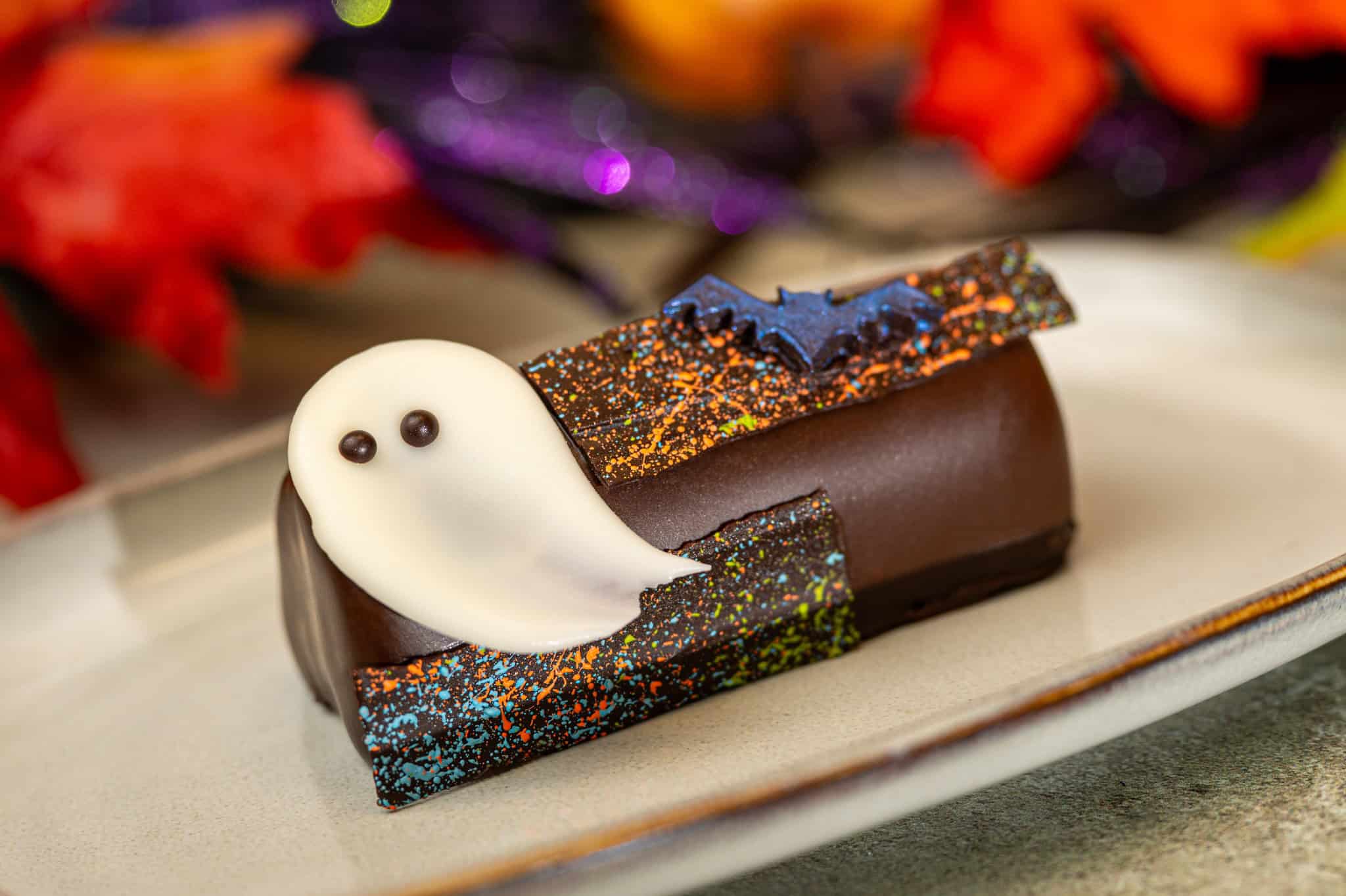 a chocolate treat shaped like a log with a white candy ghost 