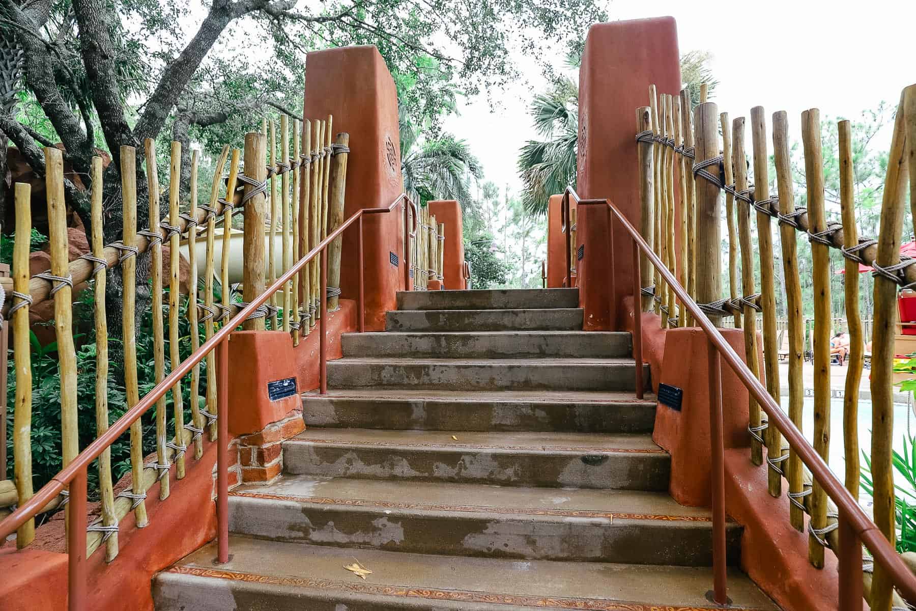 steps leading up to the bridge that crosses the pool 