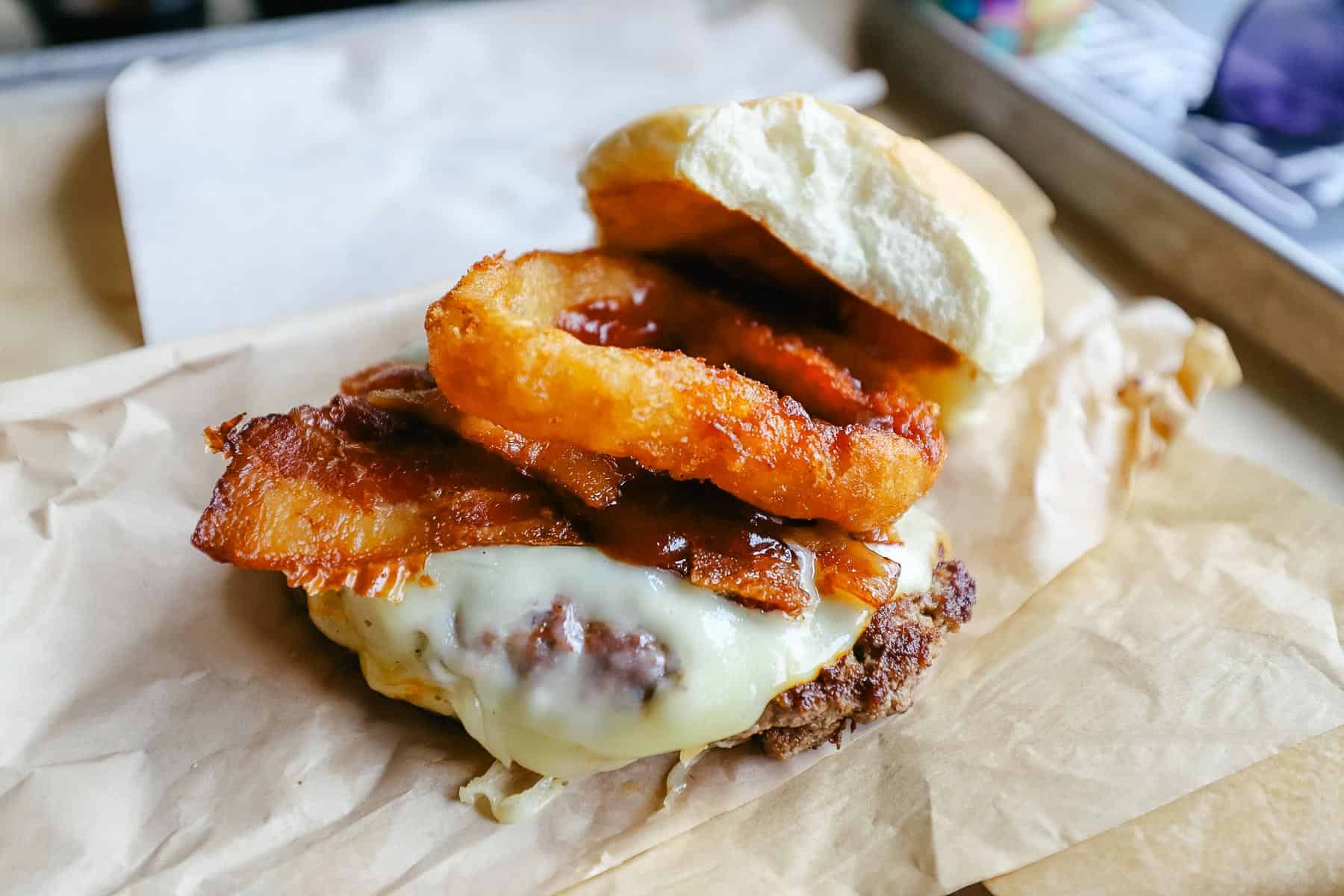 D-luxe Burger's barbecued burger comes with cheese, bacon, onion ring, and barbecue sauce. 
