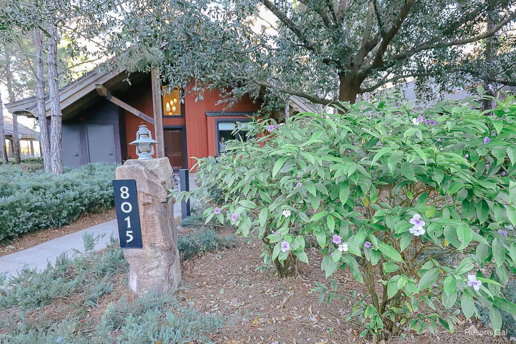 a Cascade cabin with landscaping around it 