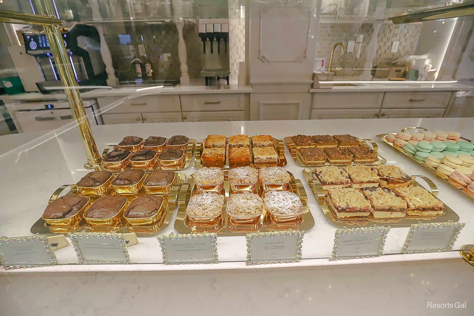 a display case with various bars like brownies, apple pie, magic bars