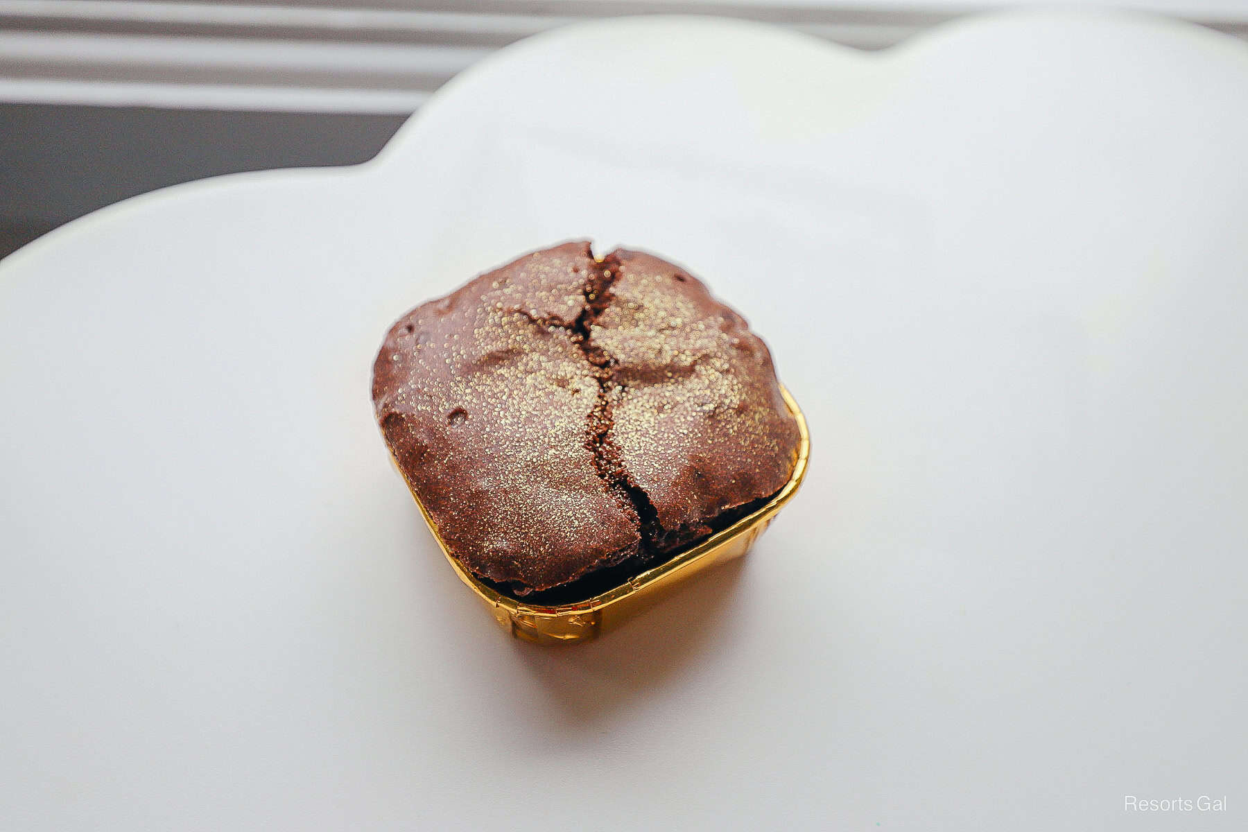 a closeup of the gluten free brownie from the Cake Bake Shop that's dusted in gold glitter 
