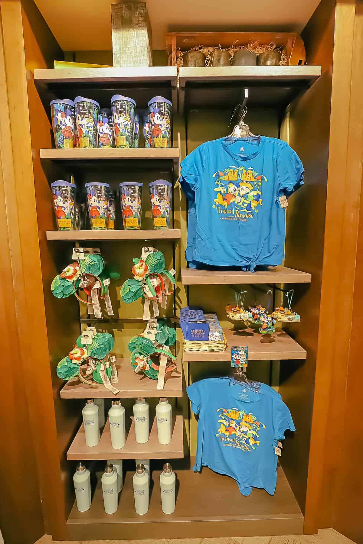 Caribbean Beach Resort branded t-shirts, Minnie Ears, and tumblers