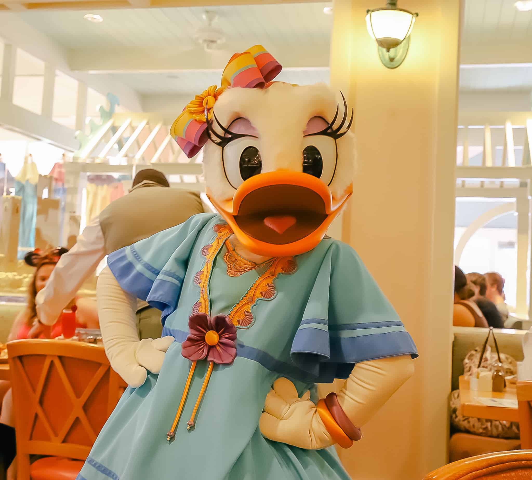 Daisy posing for a photo at a restaurant at Disney's Beach Club.