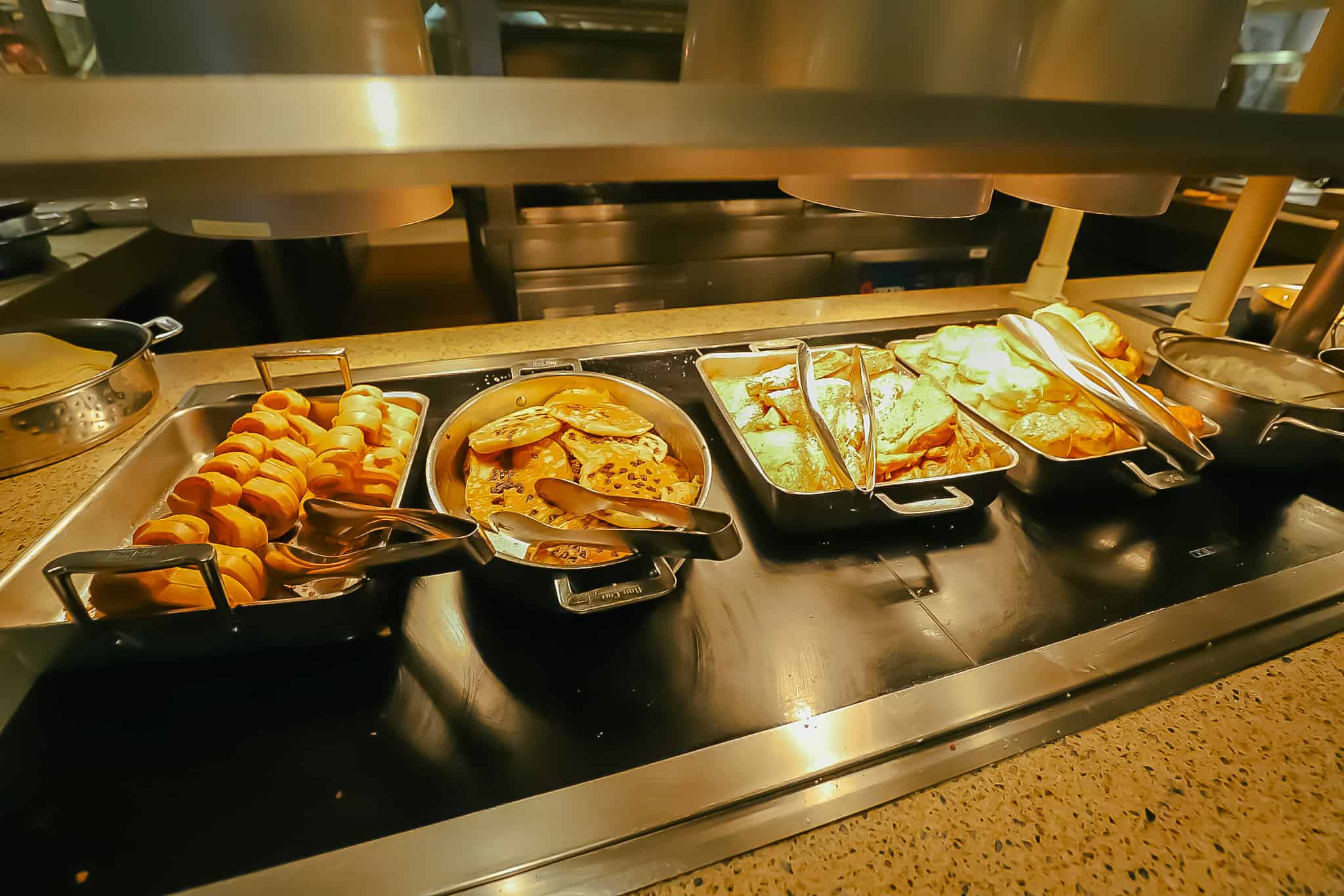 a portion of the buffet with Mickey Waffles, pancakes, and biscuits