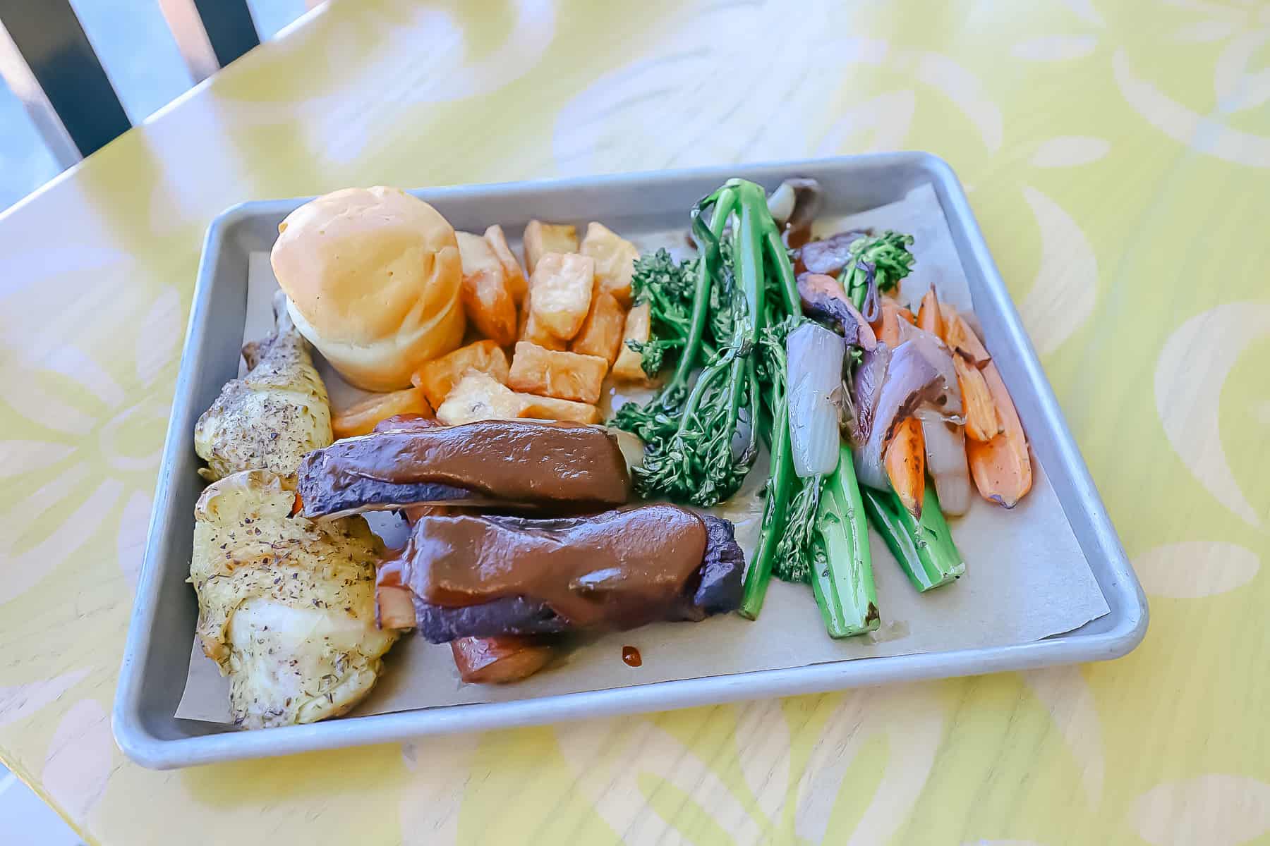 An item we ordered called the mixed grill platter that contains chicken, ribs, sausage, yucca, and veggies. 