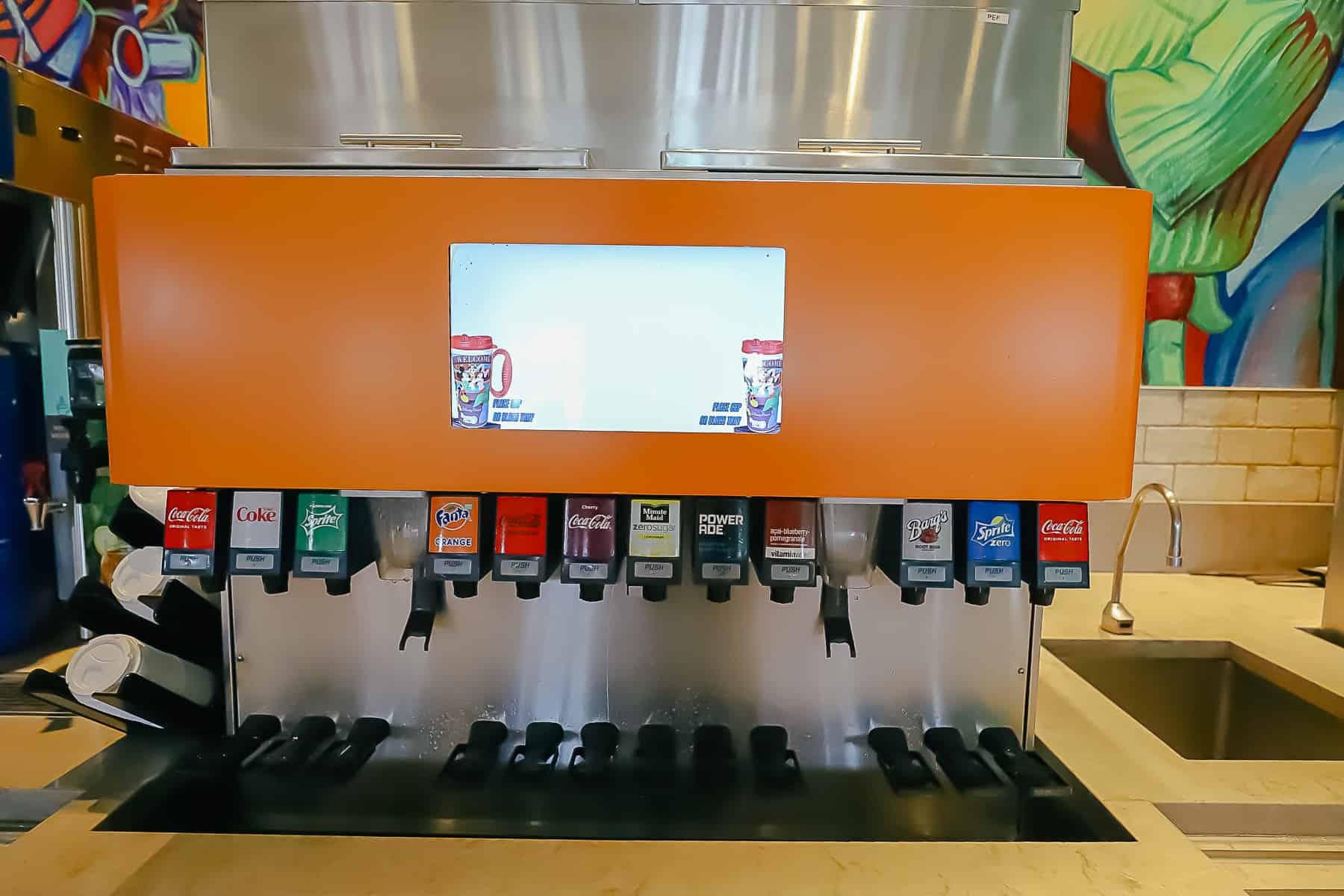 regular soda dispenser and a sink to wash mugs 