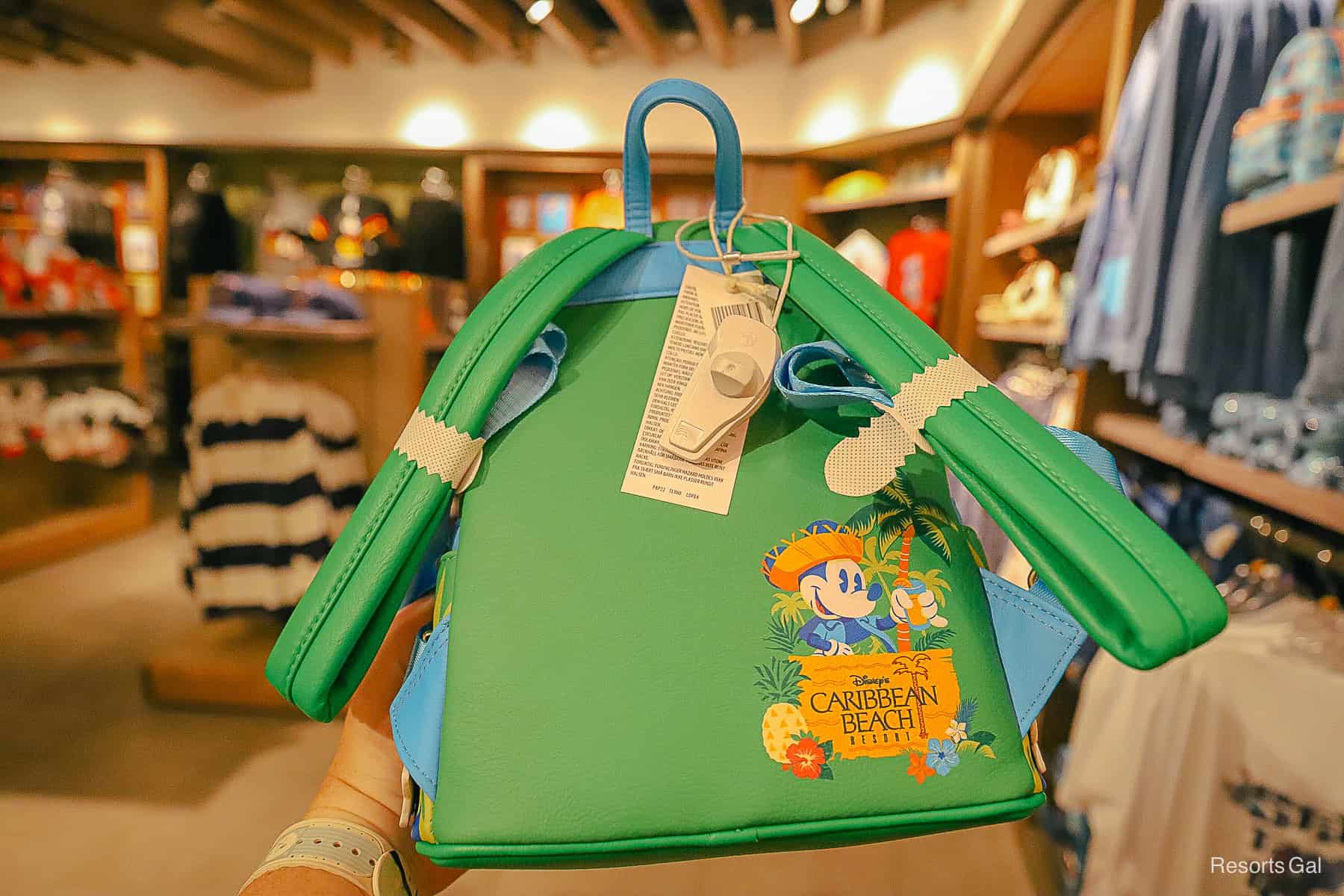 Mickey under a palm tree with the Caribbean Beach Resort logo on the backside of the Loungefly backpack 
