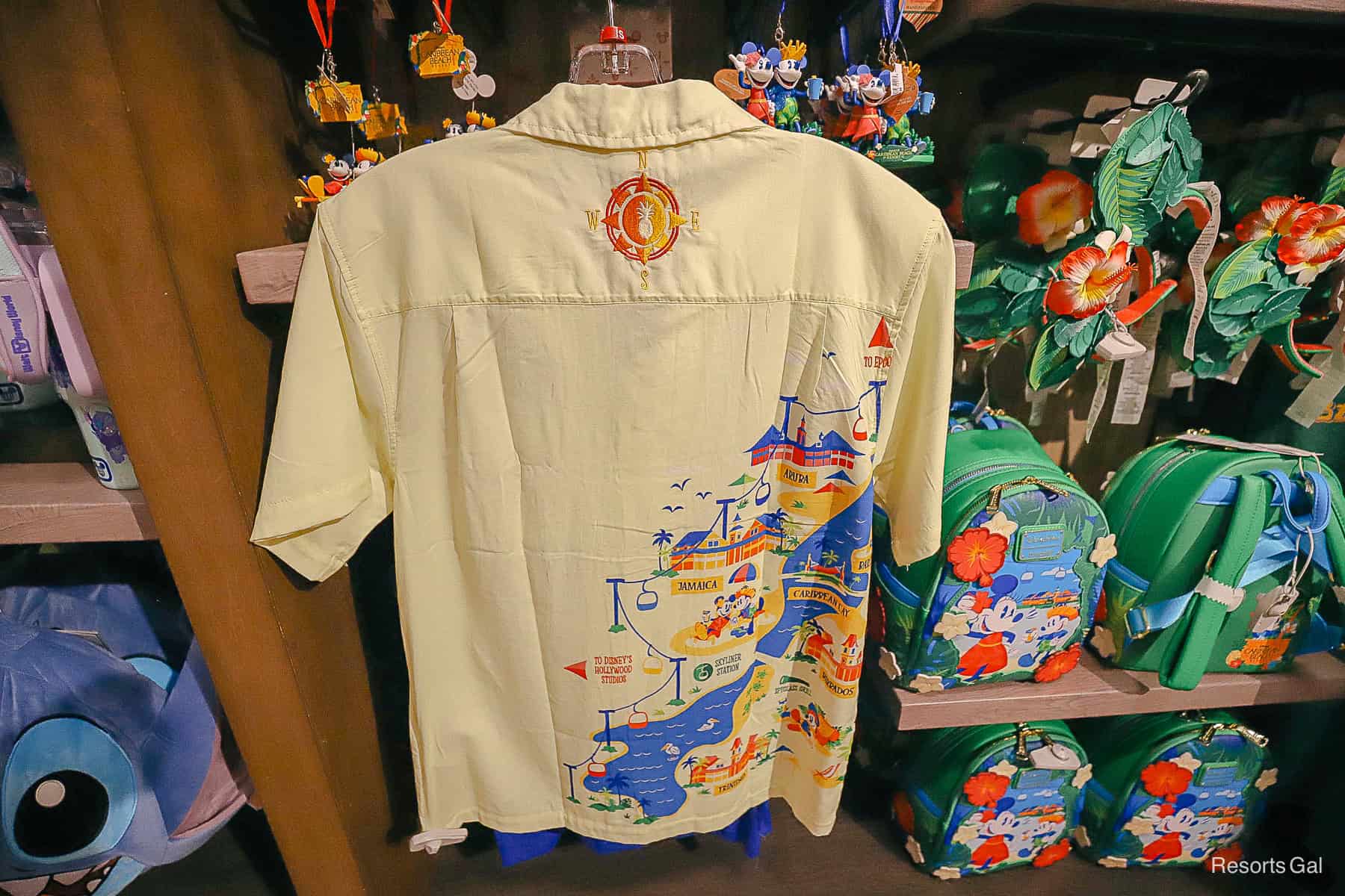 the back of the resort shirt with a compass and Skyliner scene 