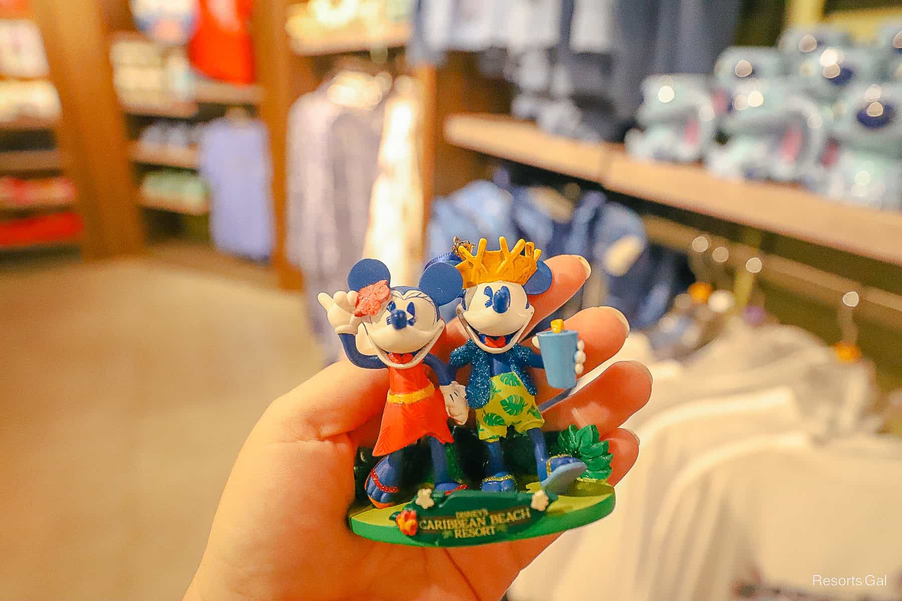 an ornament with Mickey and Minnie holding hands 