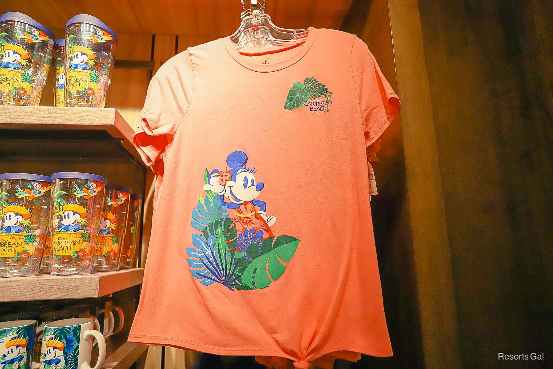 a pink shirt with Minnie Mouse and the resort hotel logo 