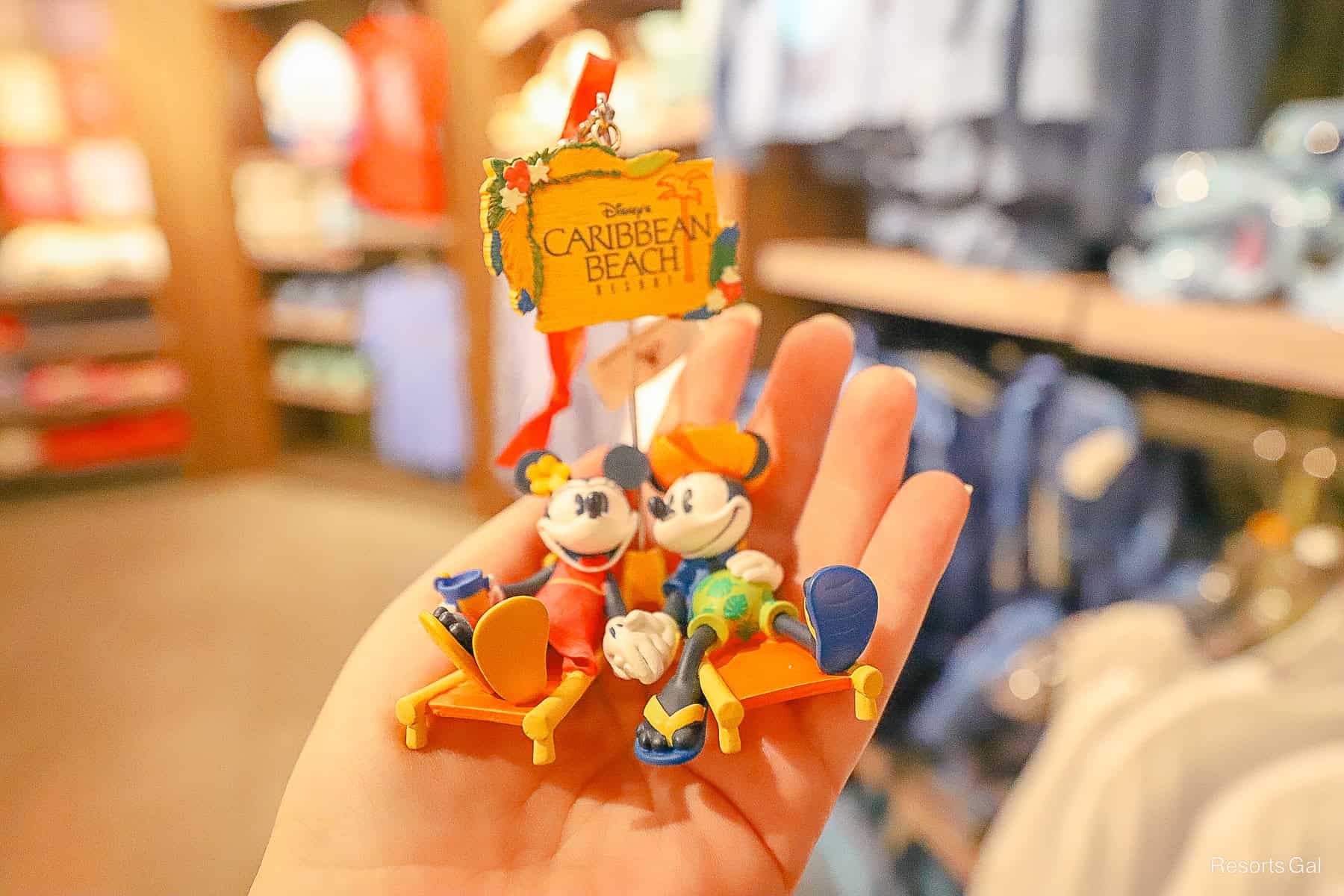 an ornament with Mickey and Minnie Mouse in lounge chairs 