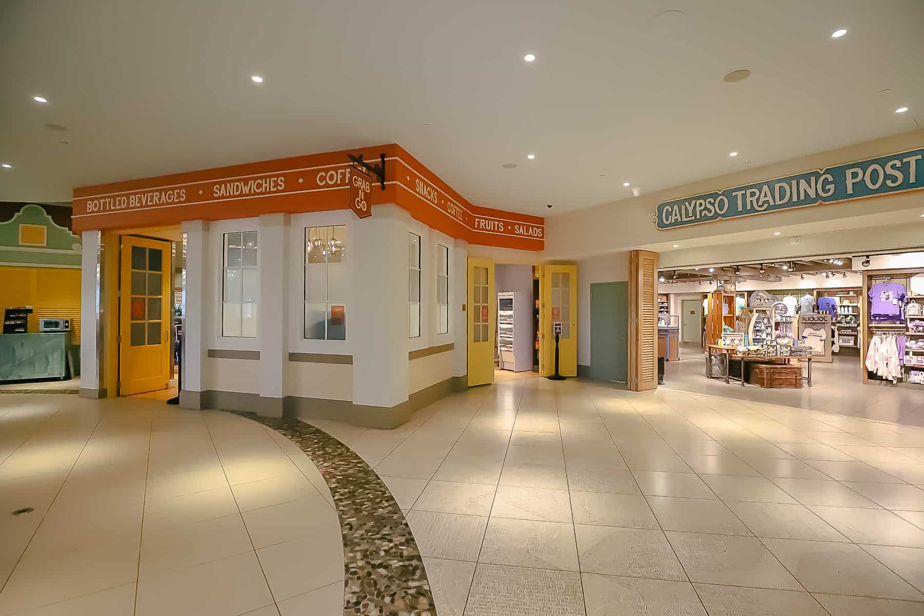 inside Old Port Royale shows entrance to Grab and Go and Calypso Trading Post 