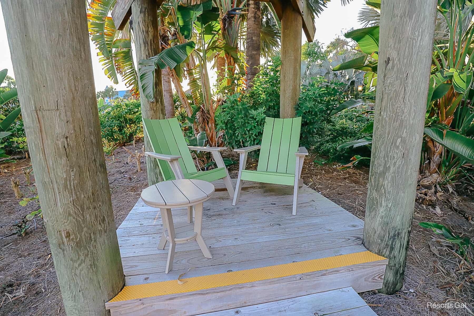 a closeup of two green chairs on Caribbean Cay where guests can relax