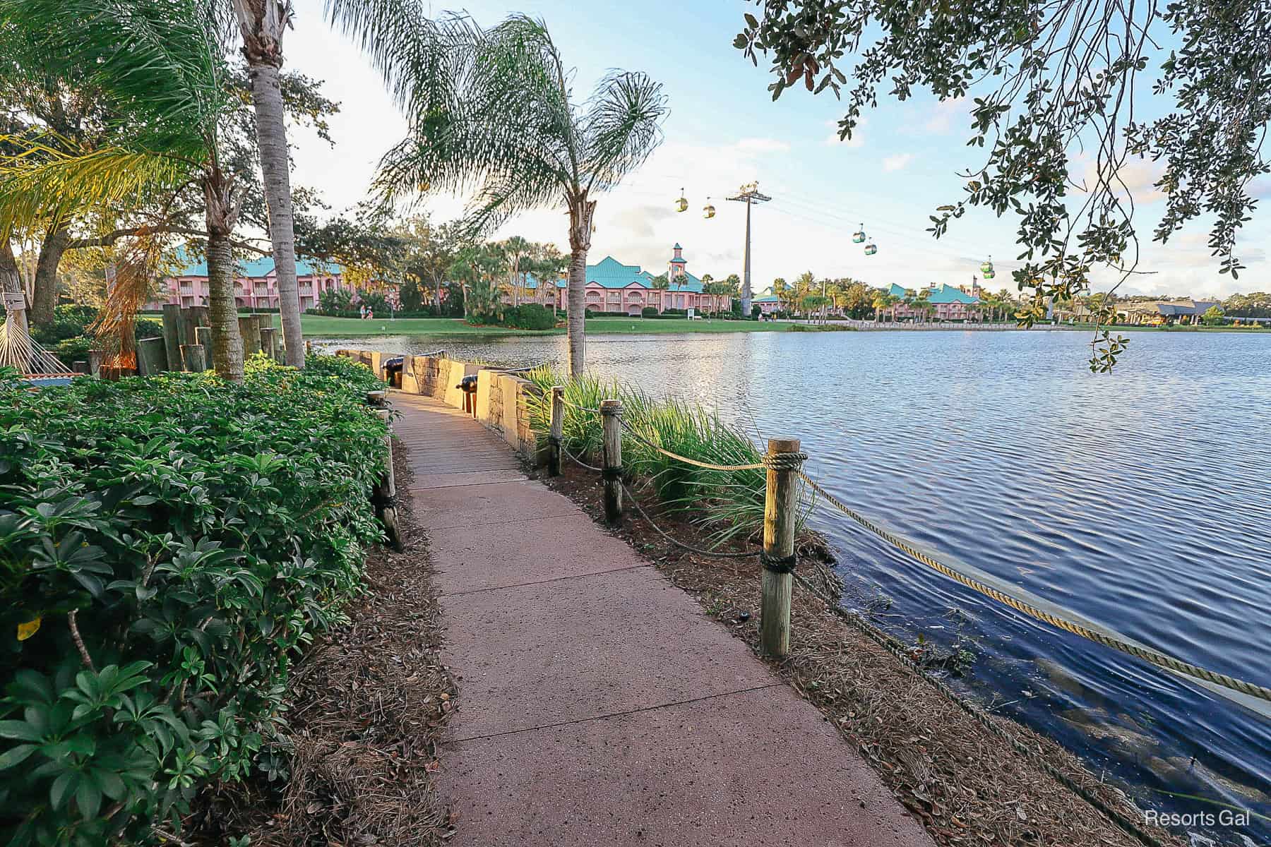 a sidewalk with a rope barrier that separates the island from the lake