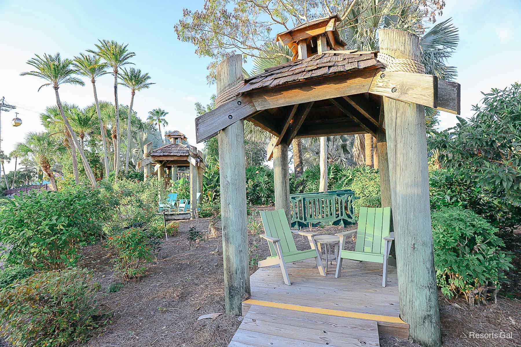 shows multiple huts with sitting areas for resort guests