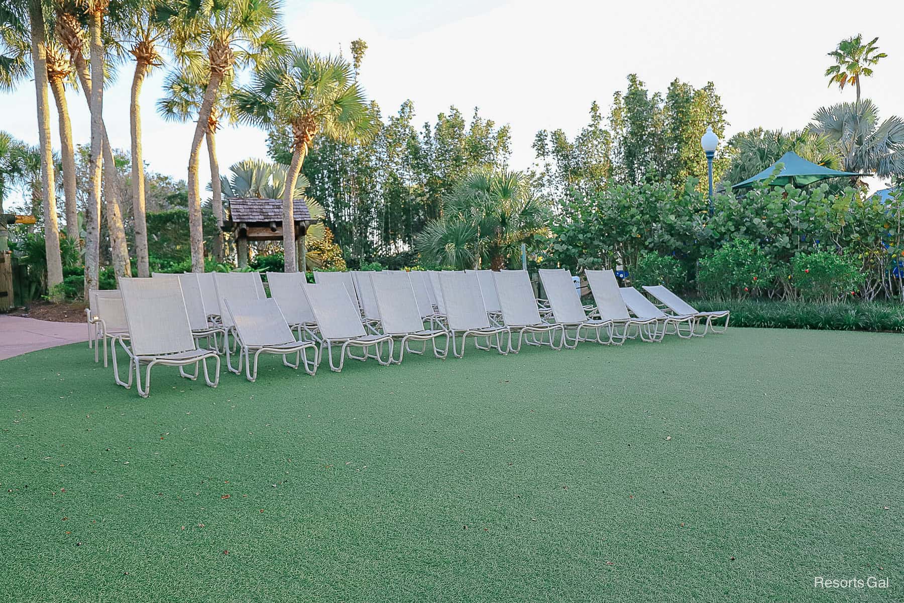 lounge chairs set up on a faux green lawn