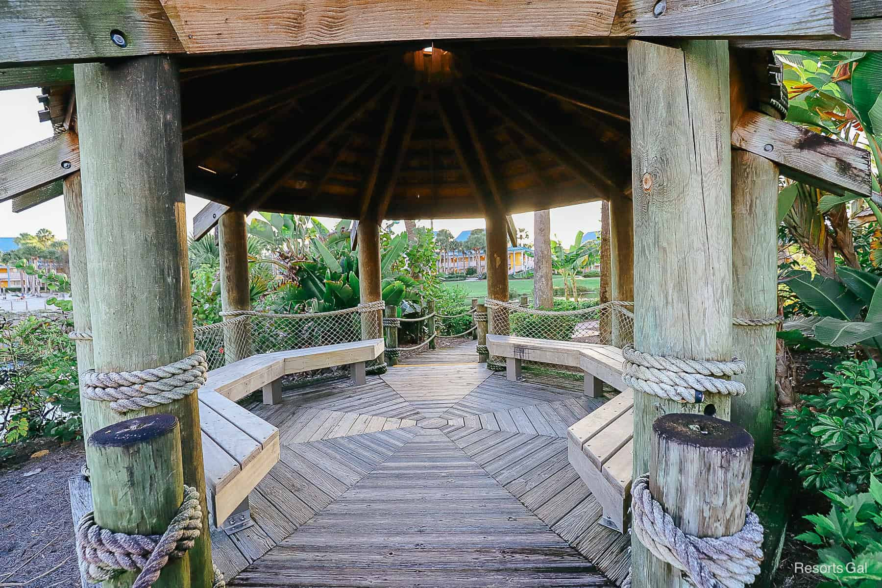 a wooden pavilion with benches