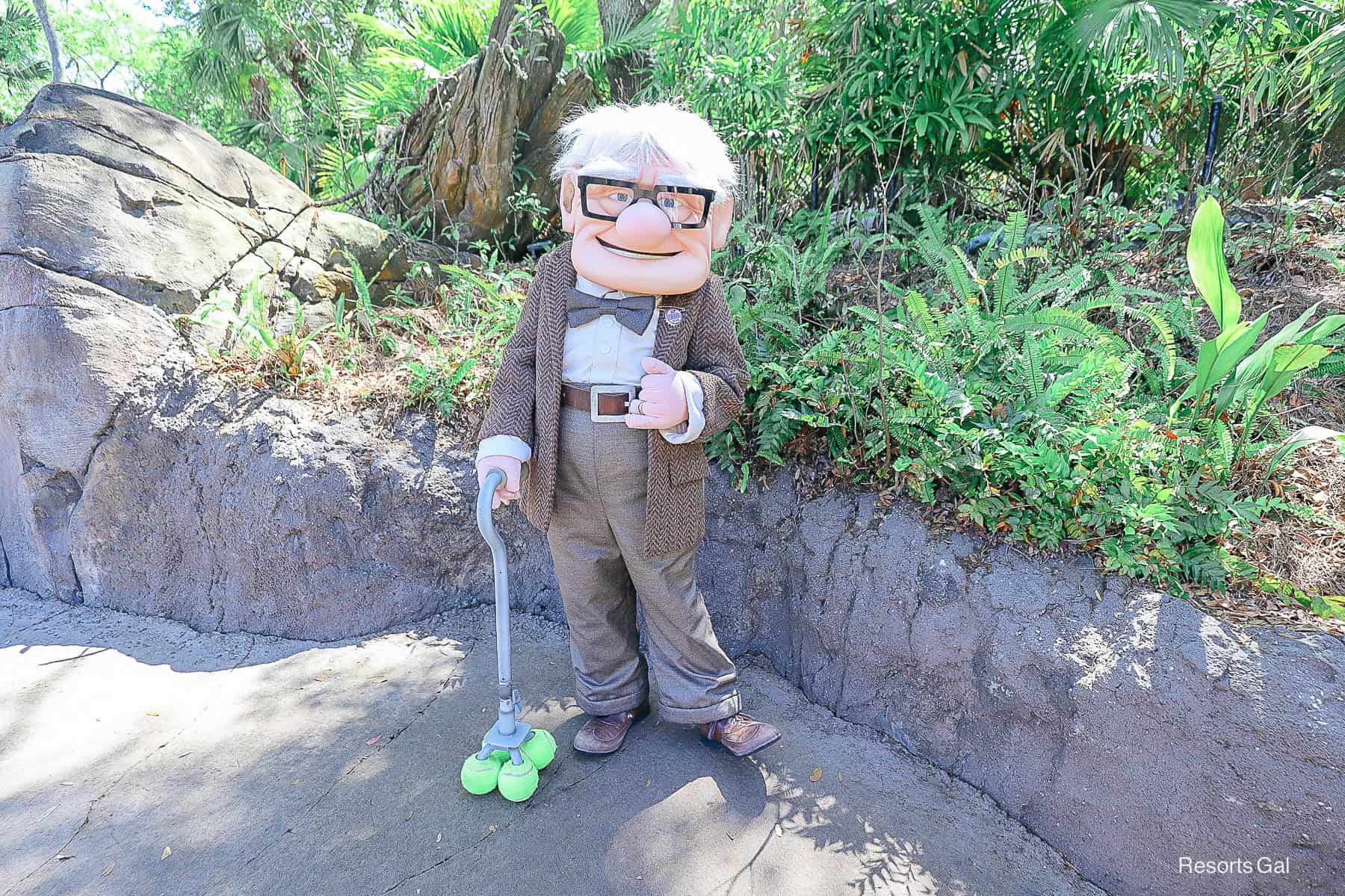 Mr. Fredricksen with his cane and glasses at Disney's Animal Kingdom