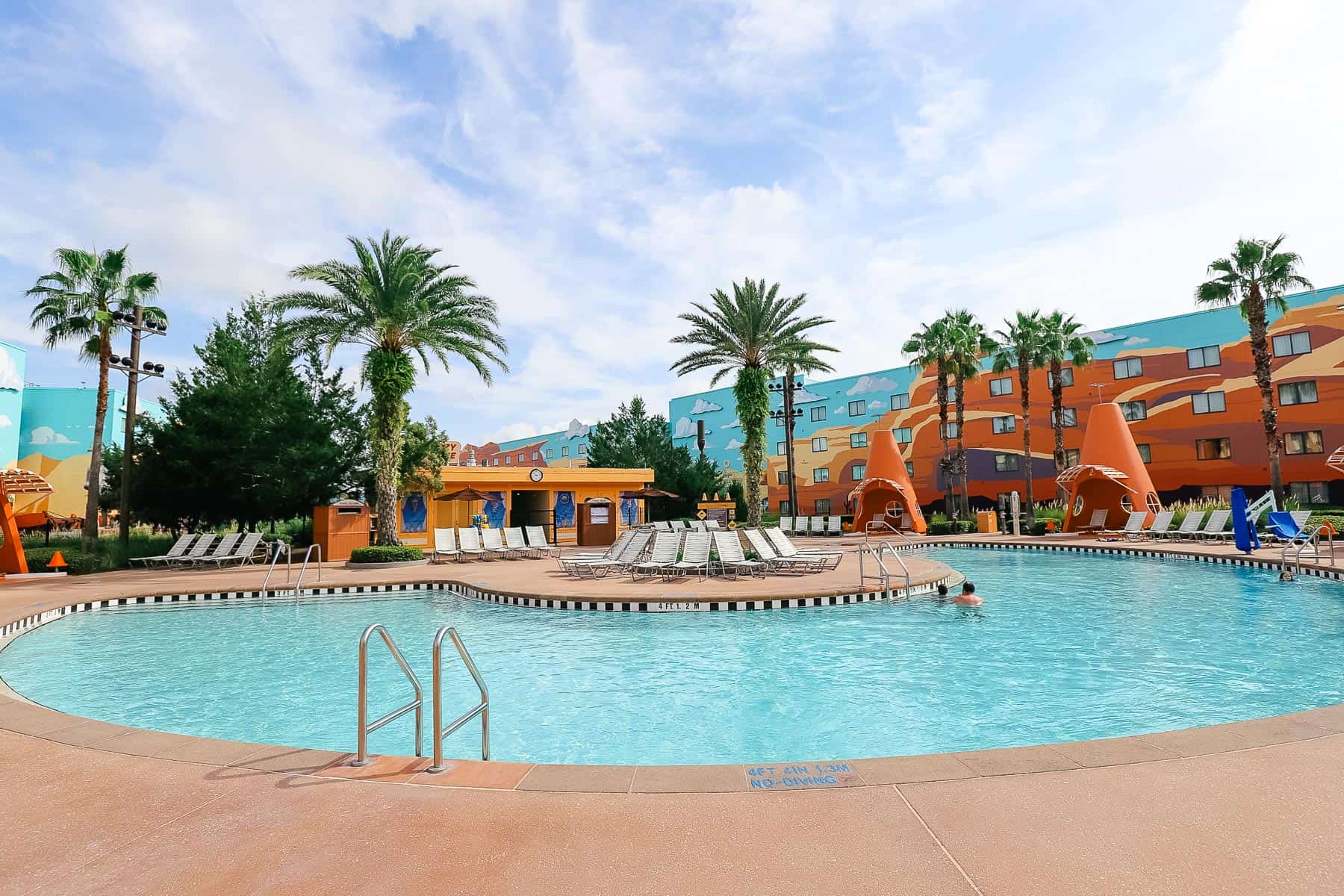 The Cozy Cone Pool at Disney's Art of Animation with palm trees in the background. 