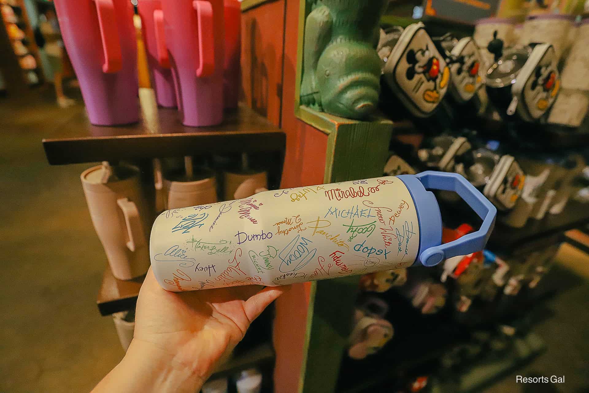 side shows a variety of character signatures displayed on the tumbler
