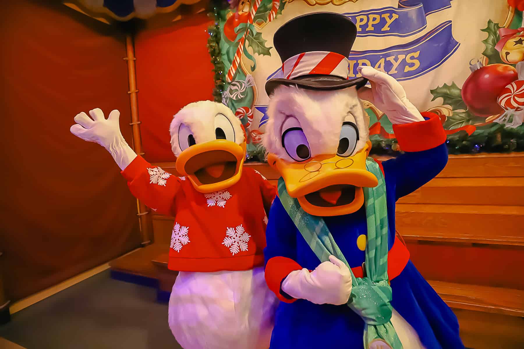 Donald and Scrooge posing for photos at Mickey's Very Merry Christmas Party in 2023. 