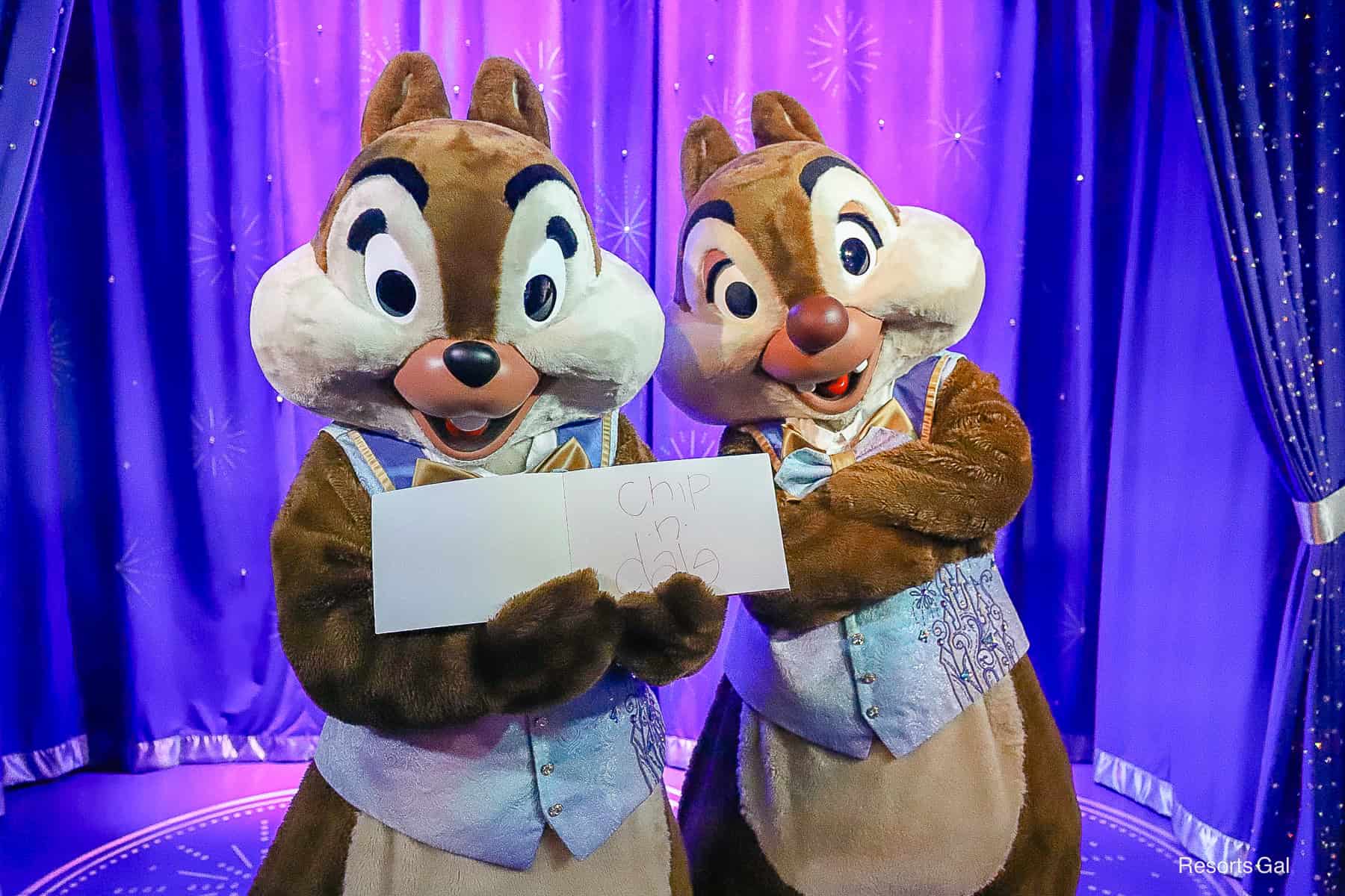 Chip and Dale holding the character autograph book