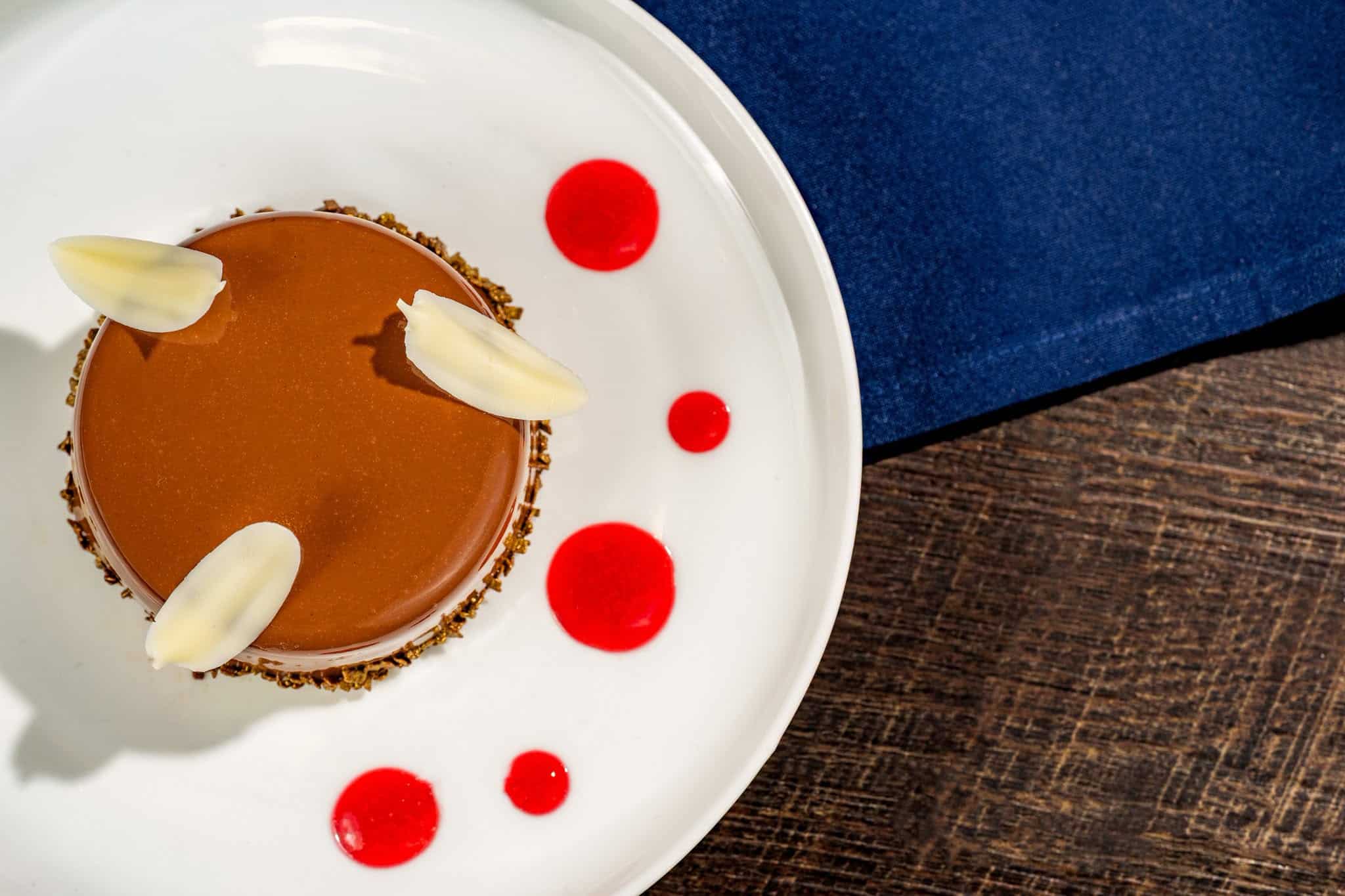 an order of Boston Cream pie with raspberry sauce