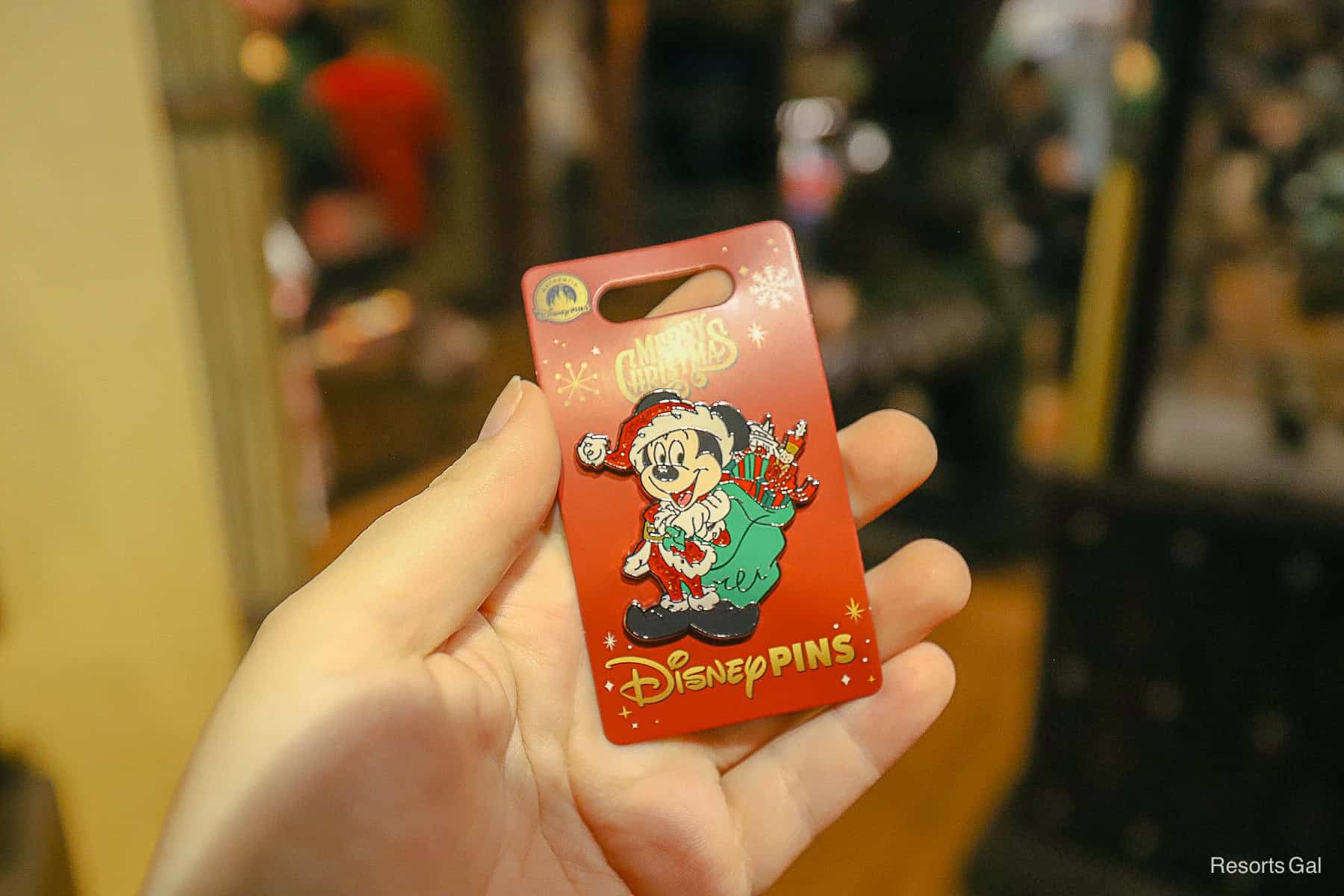 a Mickey Mouse Pin with Mickey as Santa and a bag of toys 