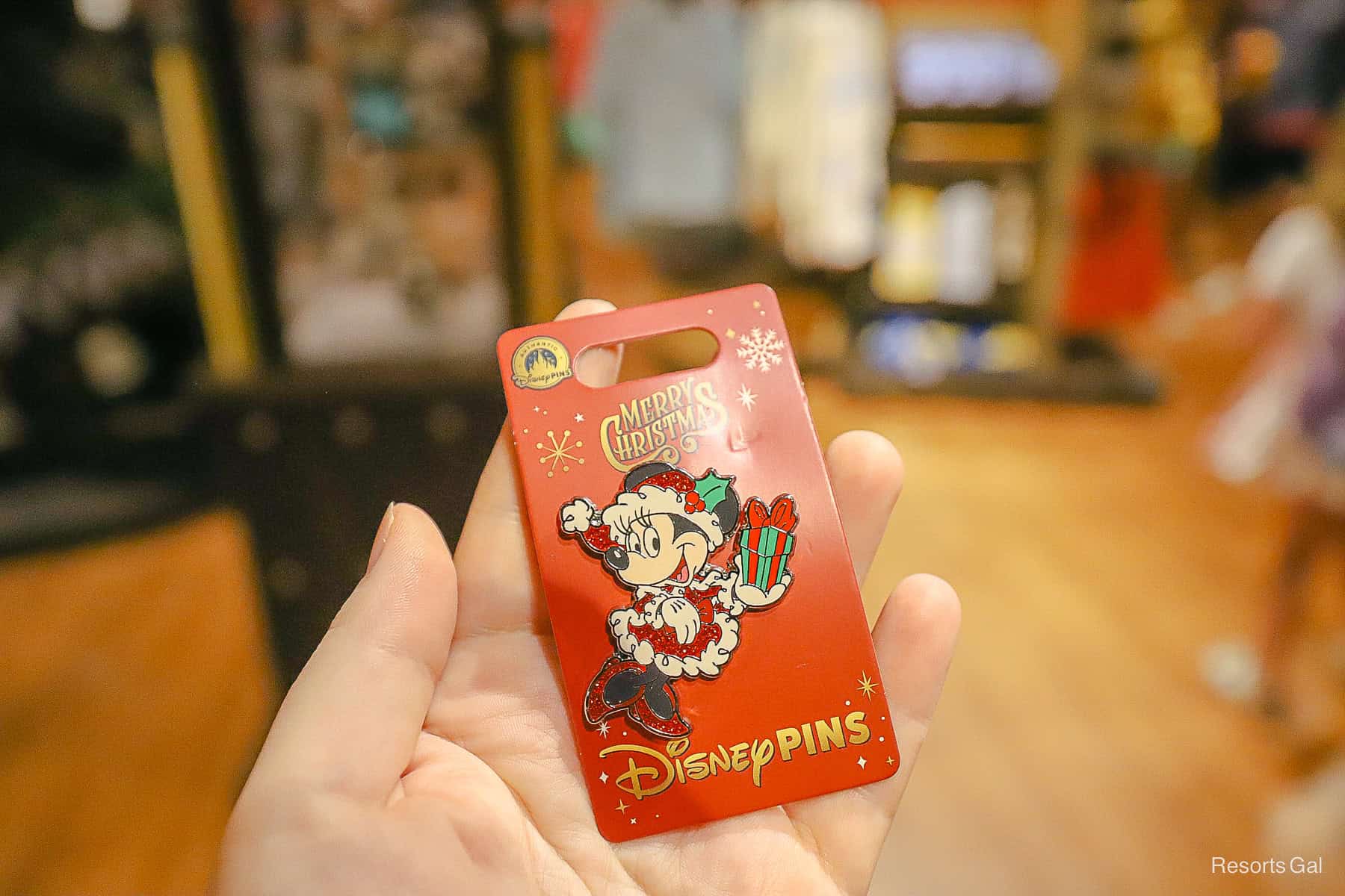 a Minnie Mouse pin with Minnie holding a package 