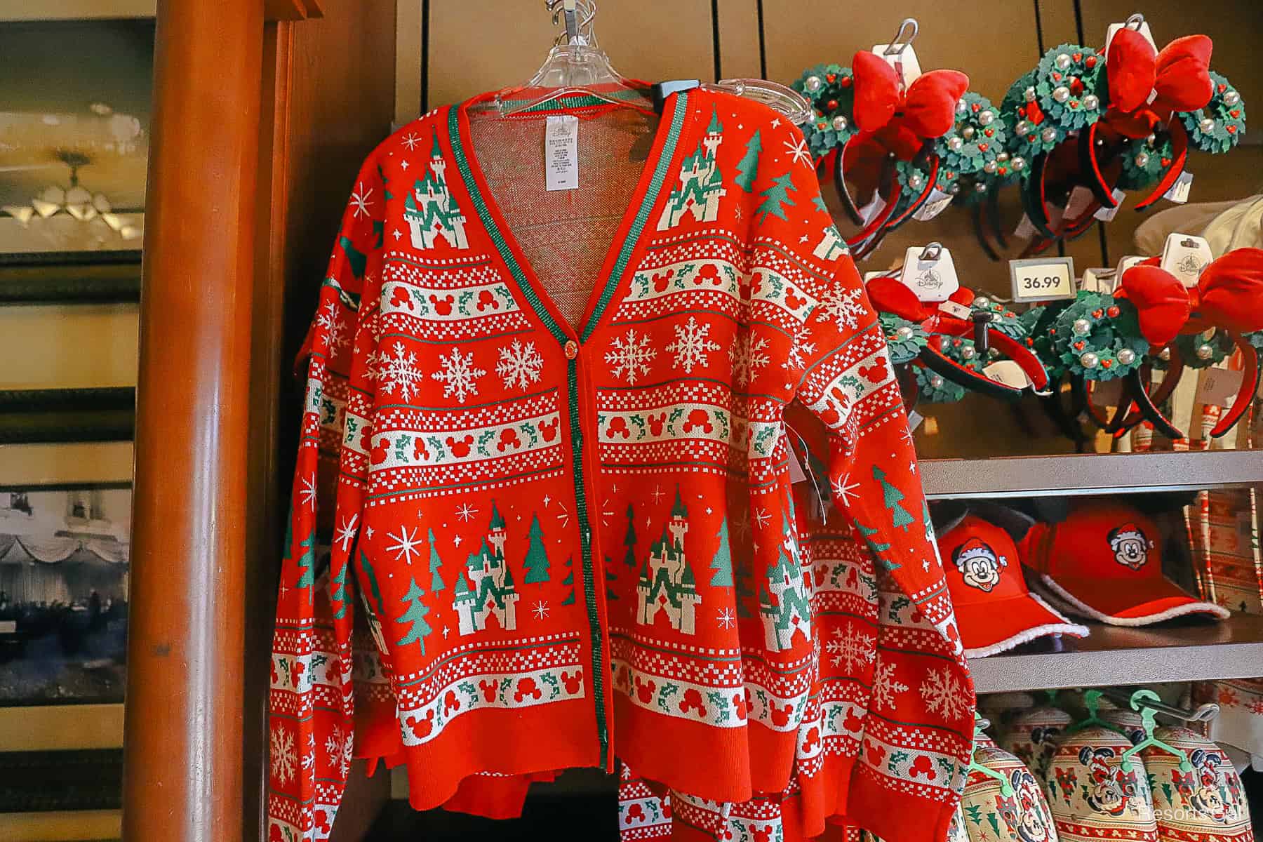 a cardigan with a Disney print in red, green, and white 