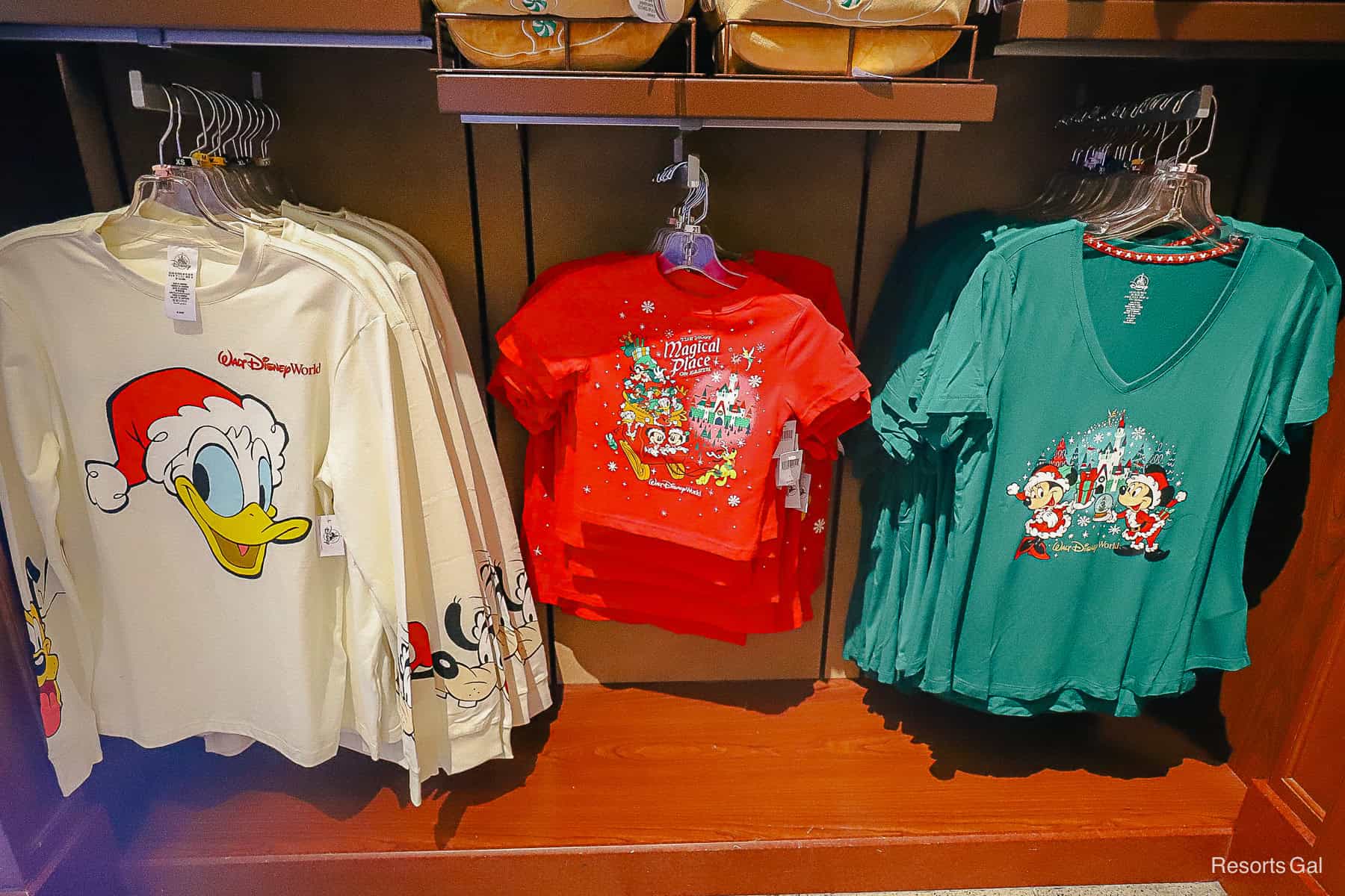 a trio of holiday shirts for a man, toddler, and a woman 