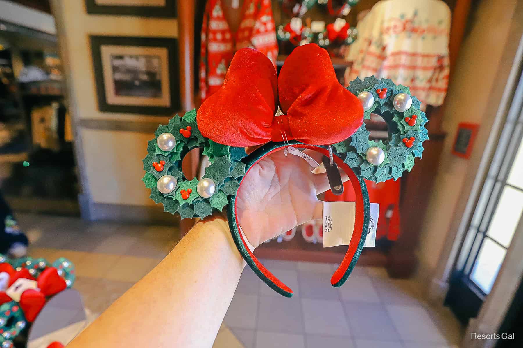 a pair of Minnie Ears with wreaths and a red bow 