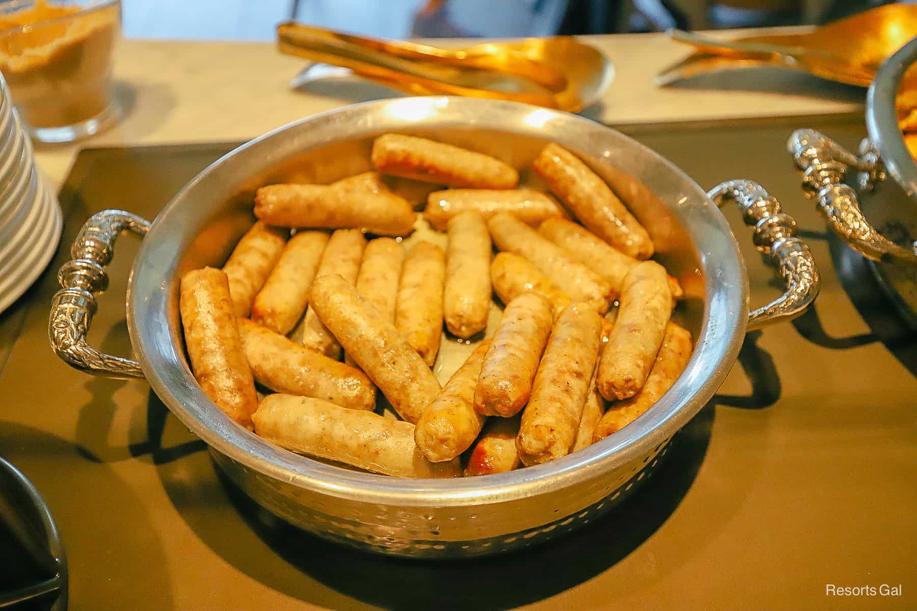 a tray filled with sausages during breakfast at the Chronos Club 