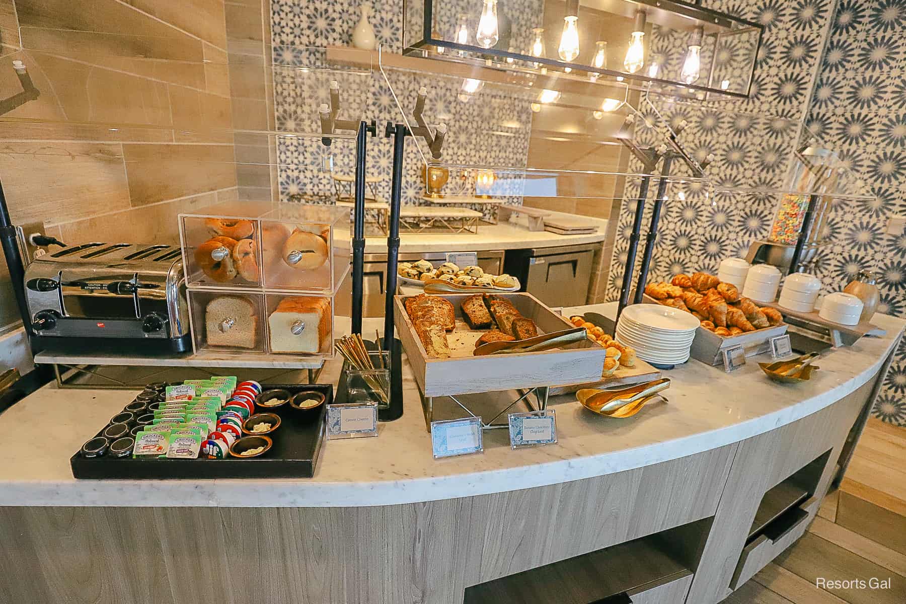 the buffet area for breakfast with various breads and other pastries 