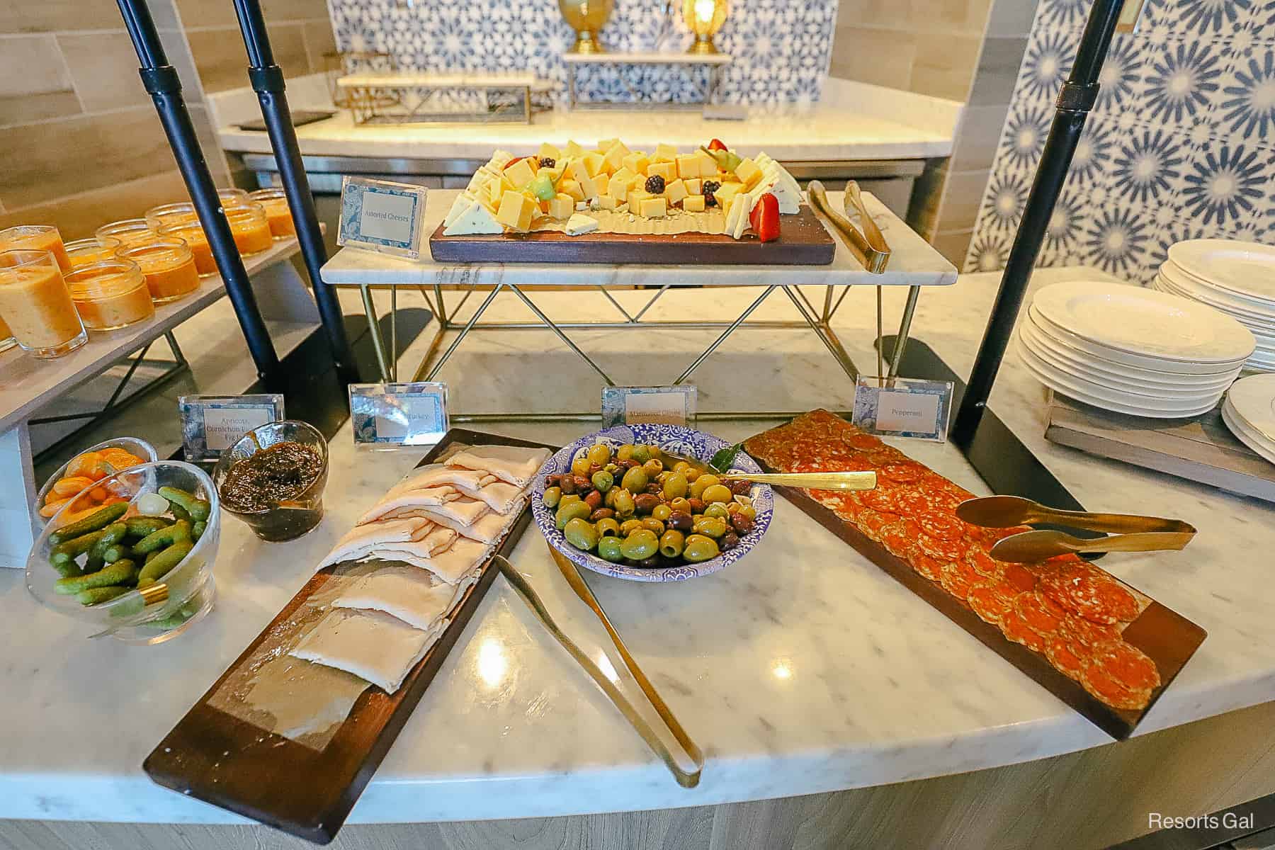 a spread with charcuterie, olives, cheese, and other small bites 