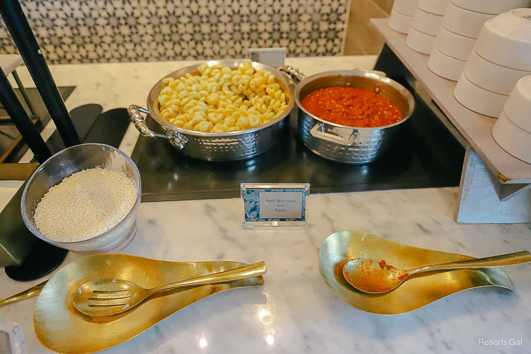 noodles with marinara and a bowl of Parmesan cheese 