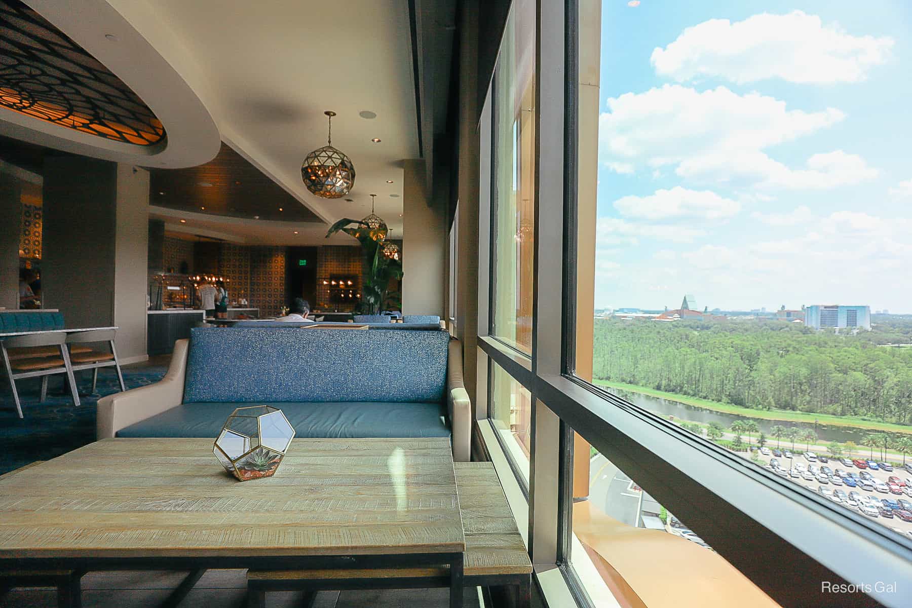 a sofa with nesting tables sitting next to a window with a view of Disney World 