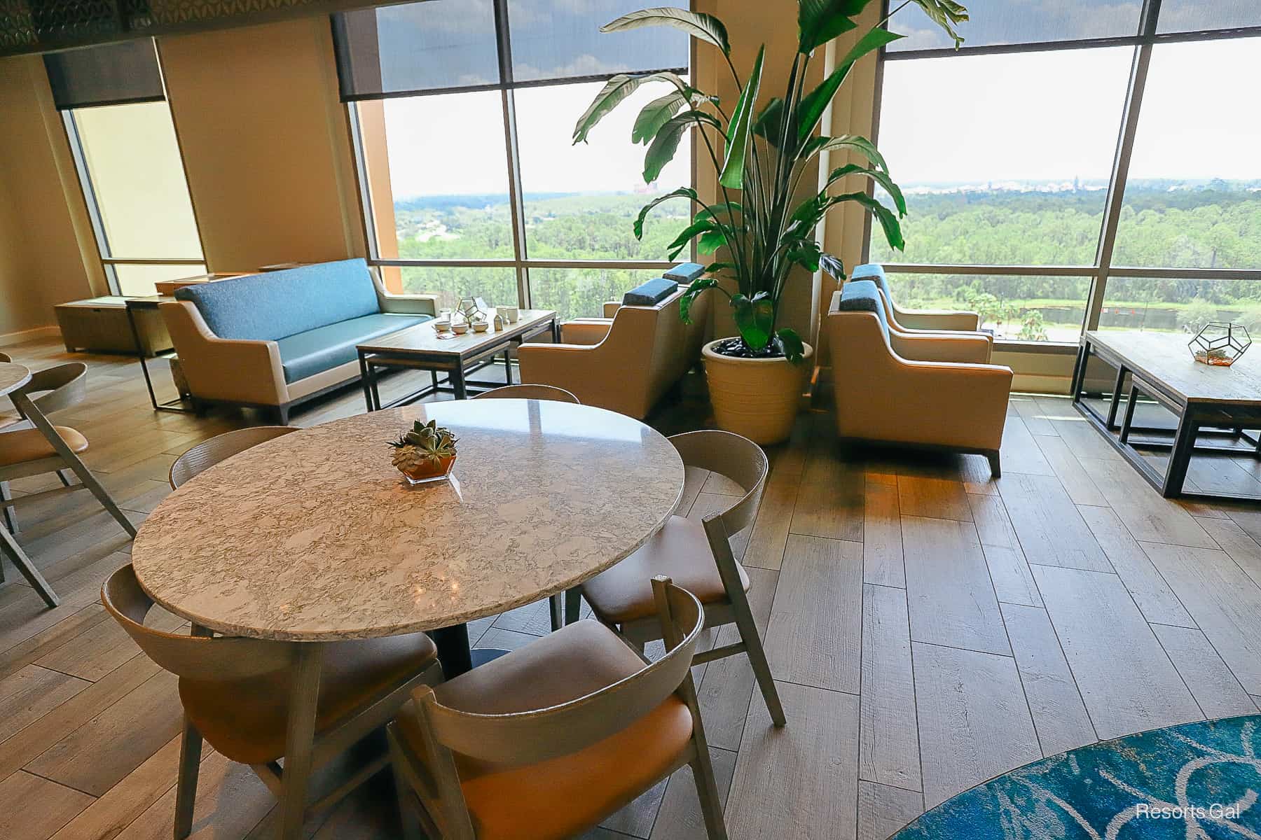 a round table with five chairs that has a marble like top 