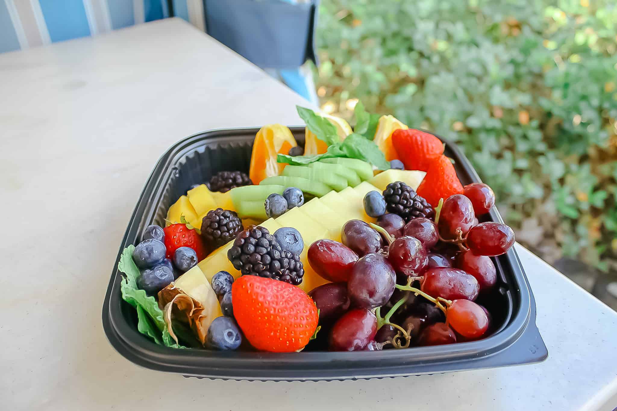 a fruit tray with strawberries, grapes, pineapple, kiwi, and more 
