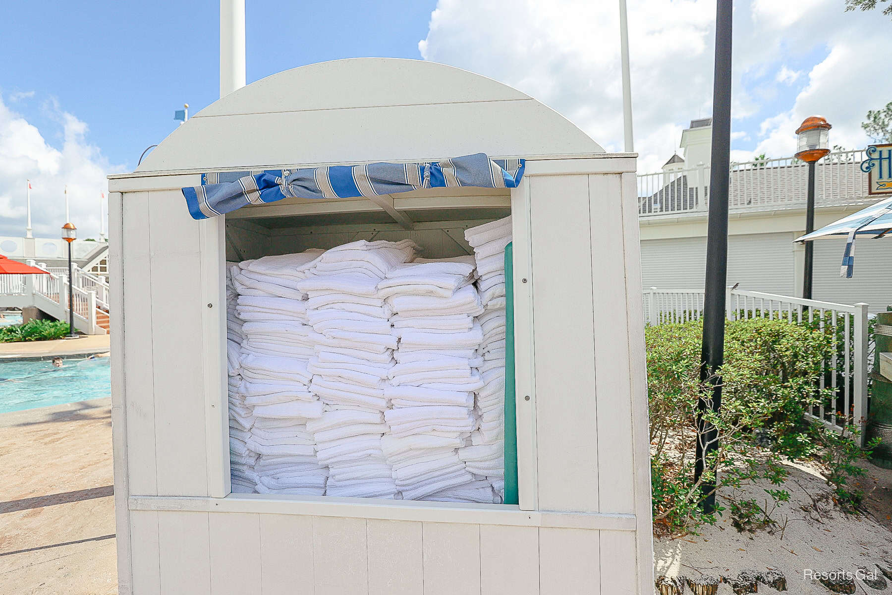 a stand with clean white towels for guests to use at the pool