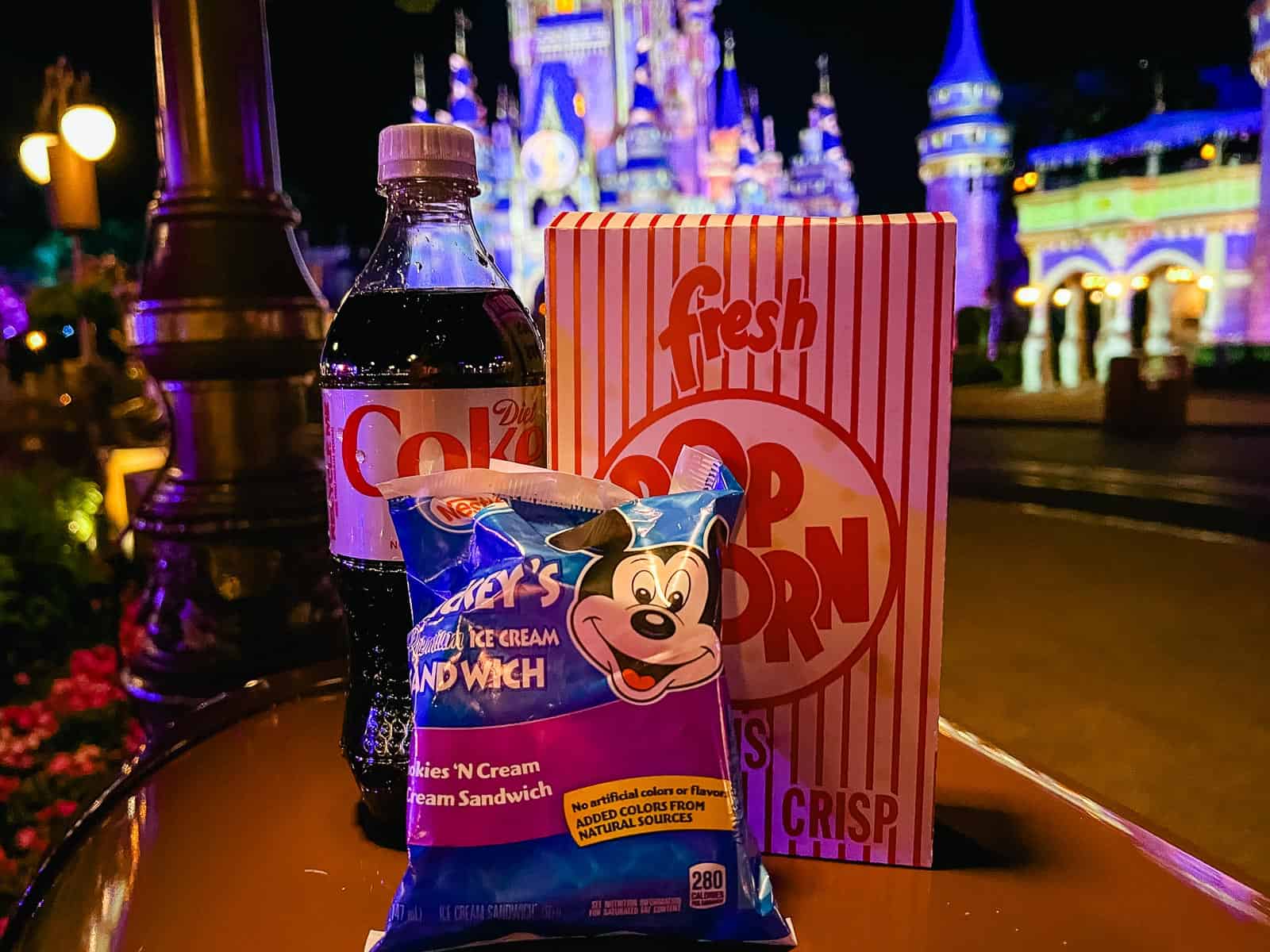 After Hours Snacks, a bottle of Diet Coke, Mickey's Ice Cream Sandwich, box of popcorn 