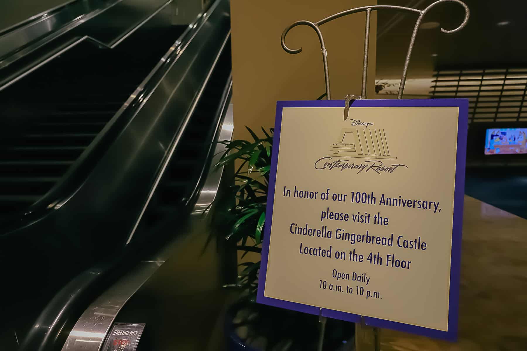 Directional that says, "In honor of our 100th anniversary please visit the Cinderella Gingerbread Castle located on the 4th floor. Open Daily from 10:00 a.m. to 10:00 p.m. 