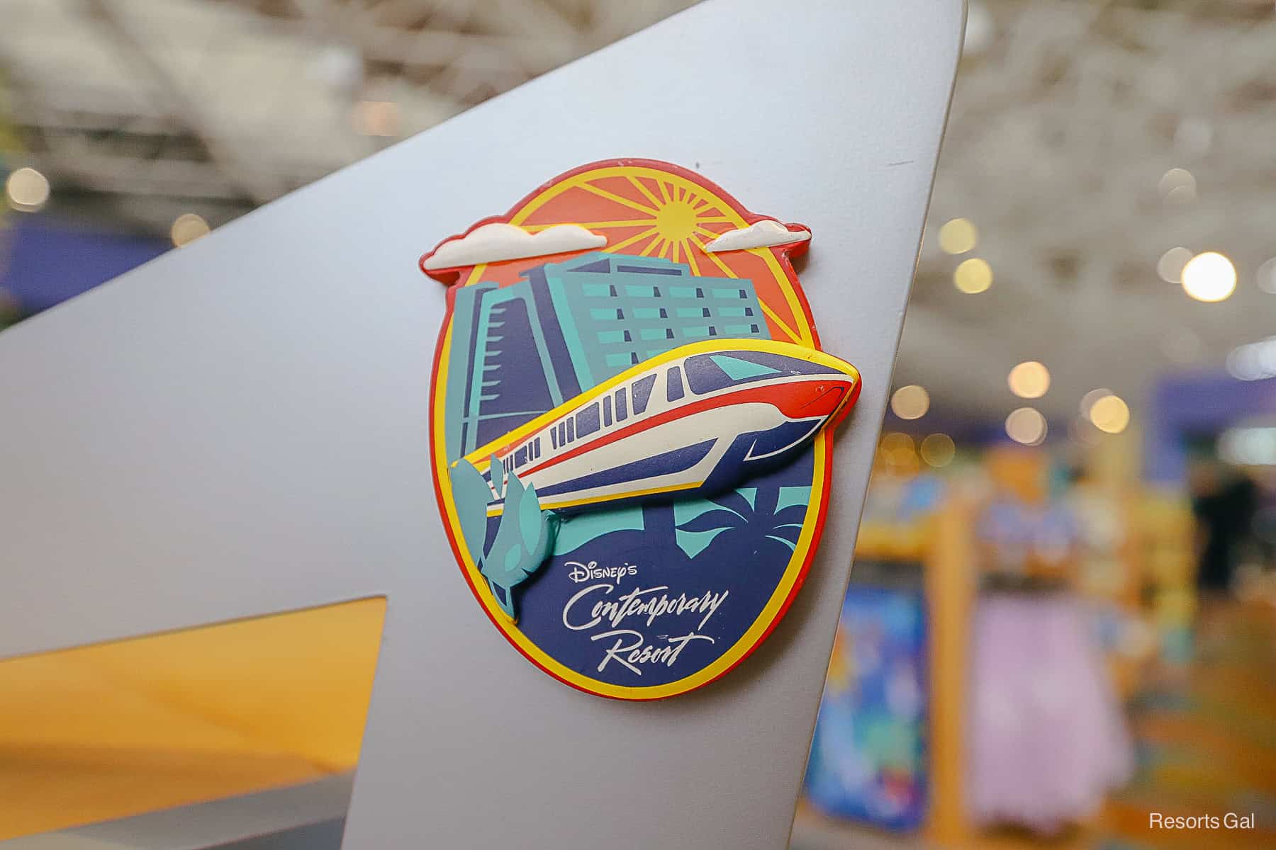 an oval shaped magnet with the red monorail passing through Disney's Contemporary design
