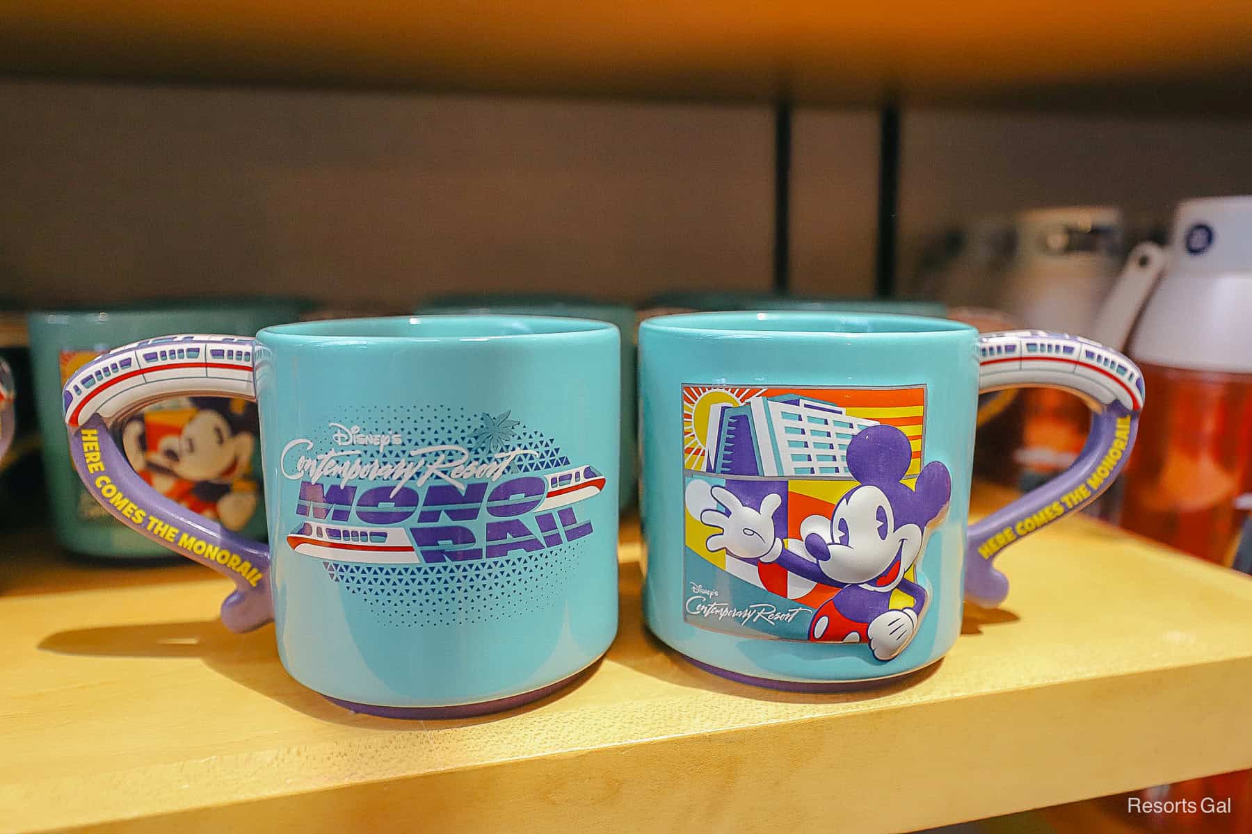 the front and back of a mug at Disney's Contemporary Resort with monorail and Mickey