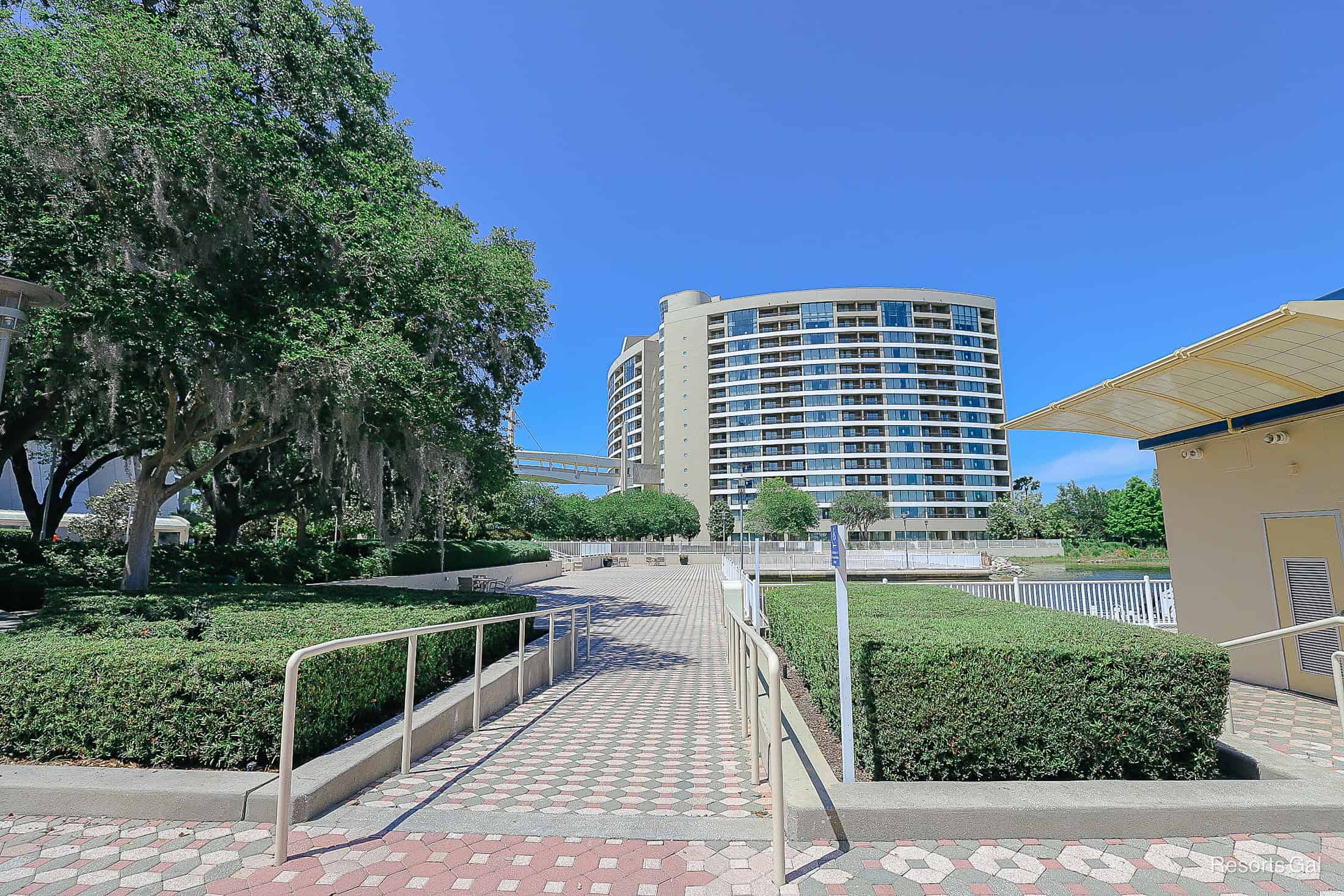 a view of a large concrete tile area with Bay Lake Tower in the backdrop 