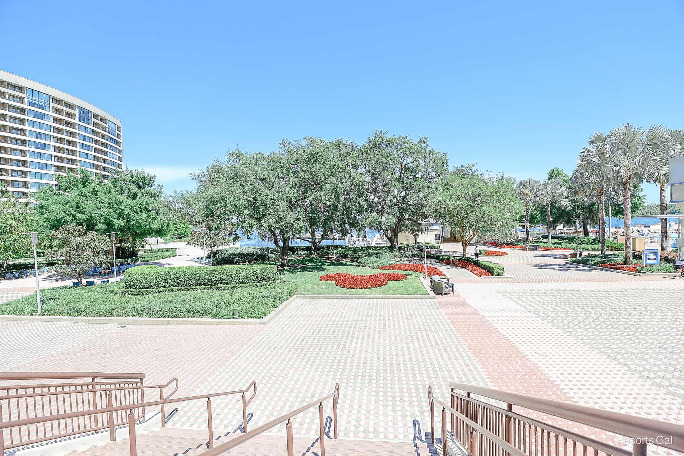 a view of the concrete meeting the luscious green landscape and Bay Lake in the distance 