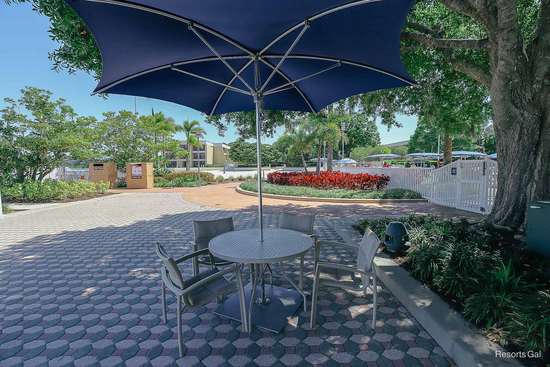 a tables and chairs in the shade near Bay Lake at Disney's Contemporary 