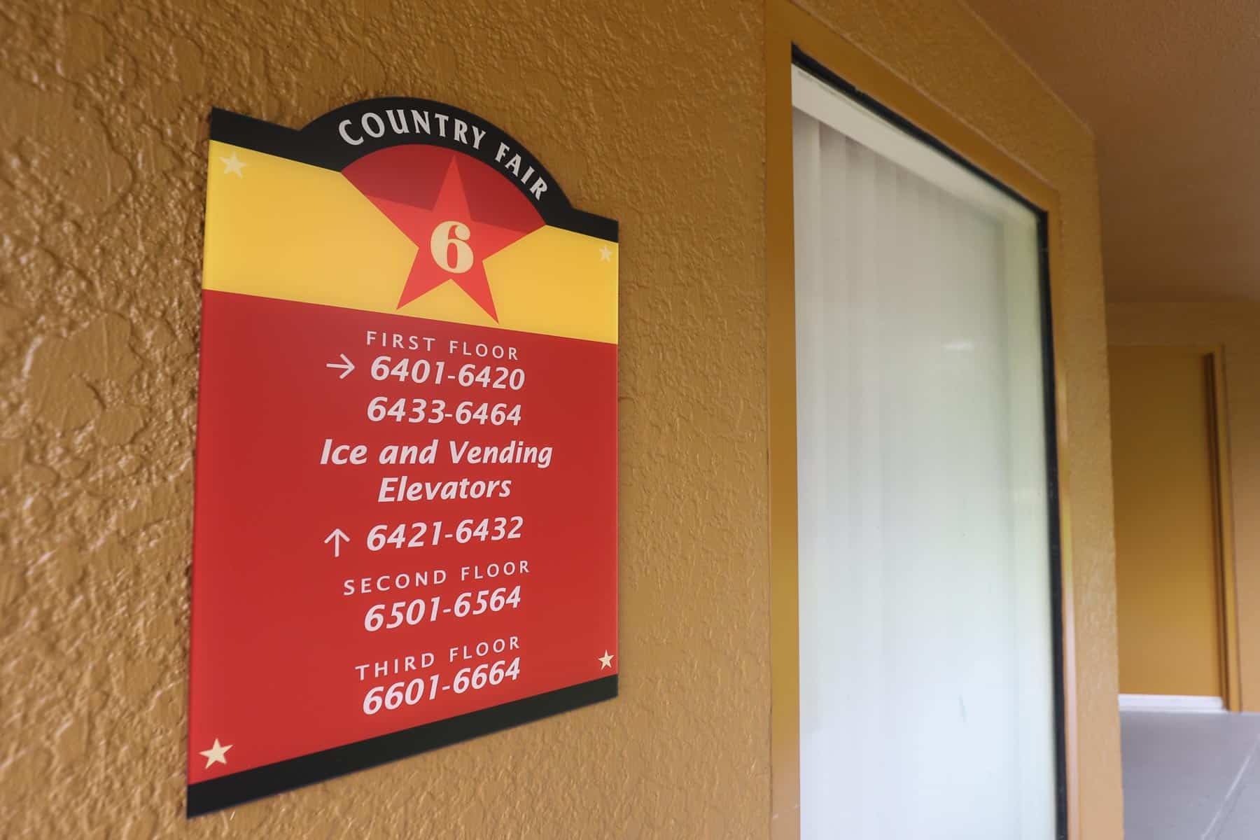 A sign with directionals for the room numbers at Disney's All-Star Music Resort 